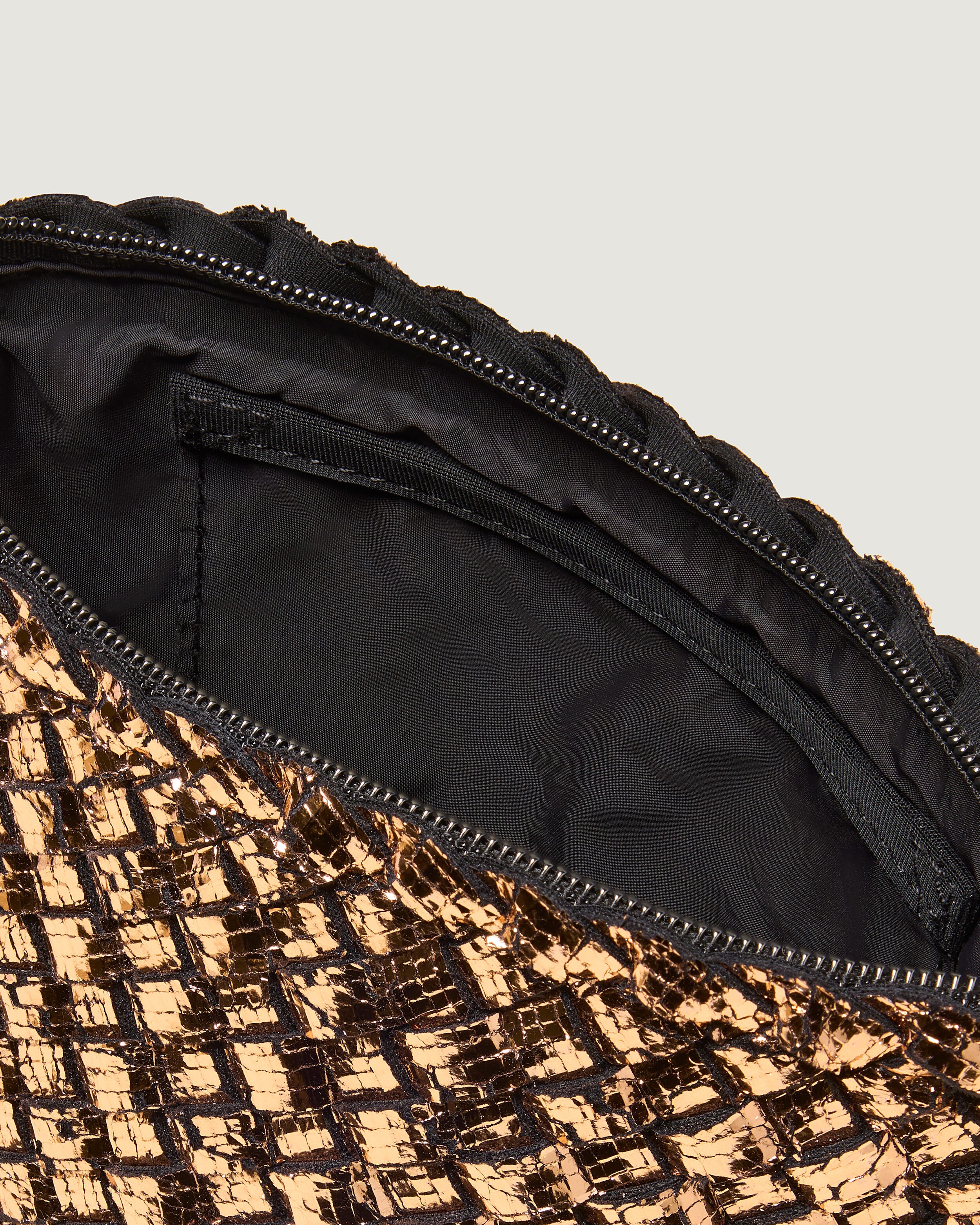 Interior close-up of Portofino Cosmetic Pouch in Rose Gold showing its zip closure, interior pocket, and wipe-clean nylon interior.