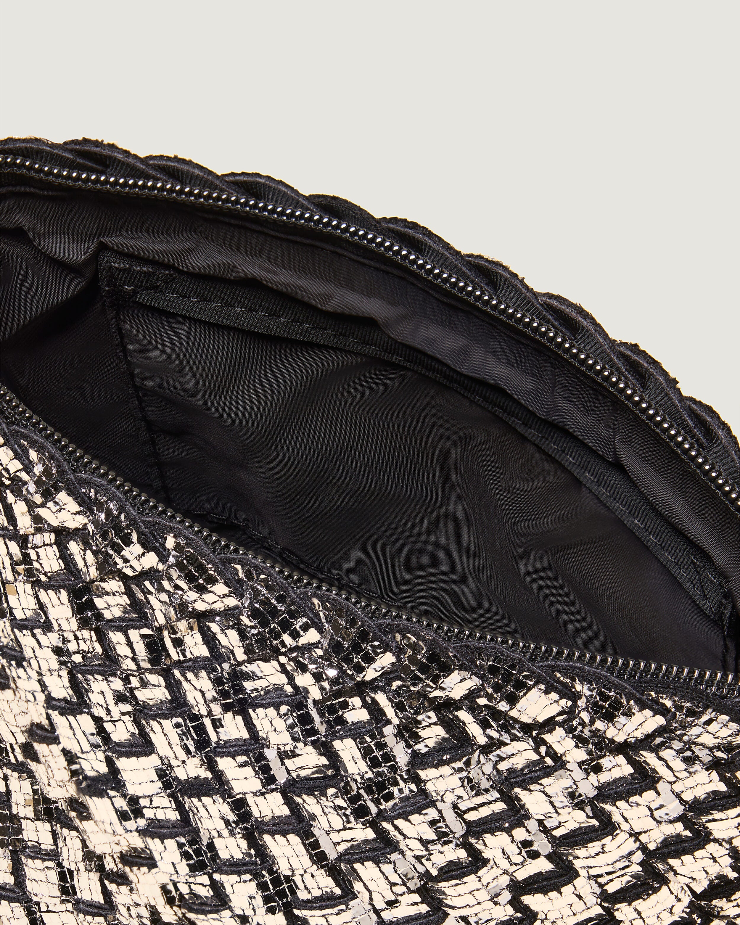 Interior close-up of Portofino Cosmetic Pouch in Silver showing its zip closure, interior pocket, and wipe-clean nylon interior.