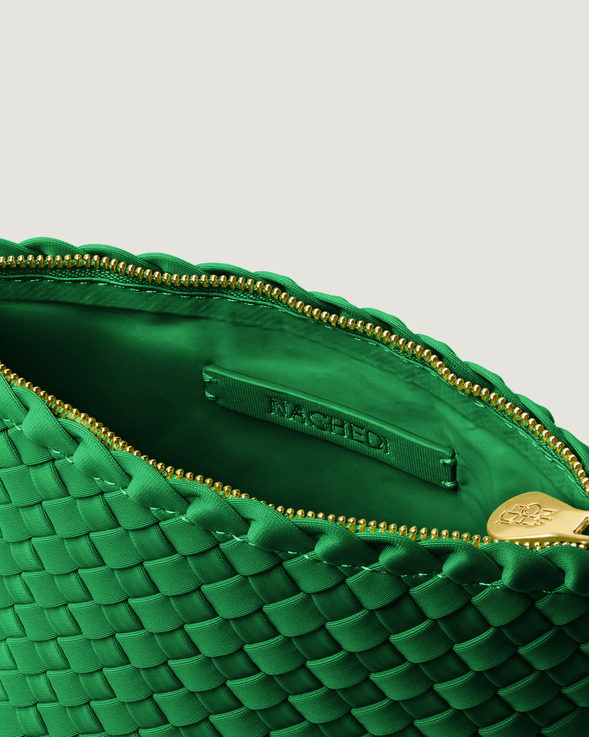 Interior close-up of Portofino Cosmetic Pouch in Emerald showing its zip closure, interior pocket, and wipe-clean nylon interior.