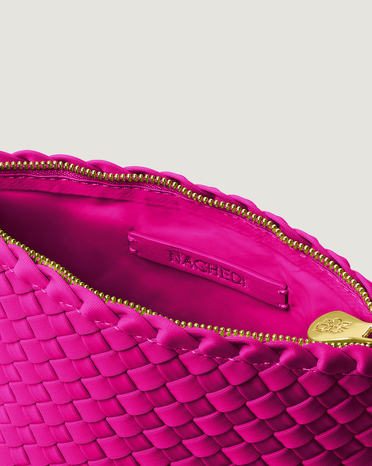 Interior close-up of Portofino Cosmetic Pouch in Miami Pink showing its zip closure, interior pocket, and wipe-clean nylon interior.