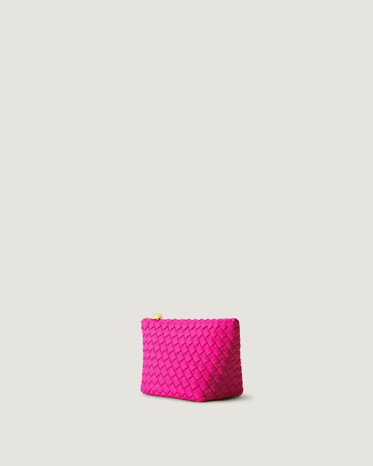 Portofino Cosmetic Pouch in Miami Pink shown from a side angle, highlighting its handwoven neoprene construction and zip closure.