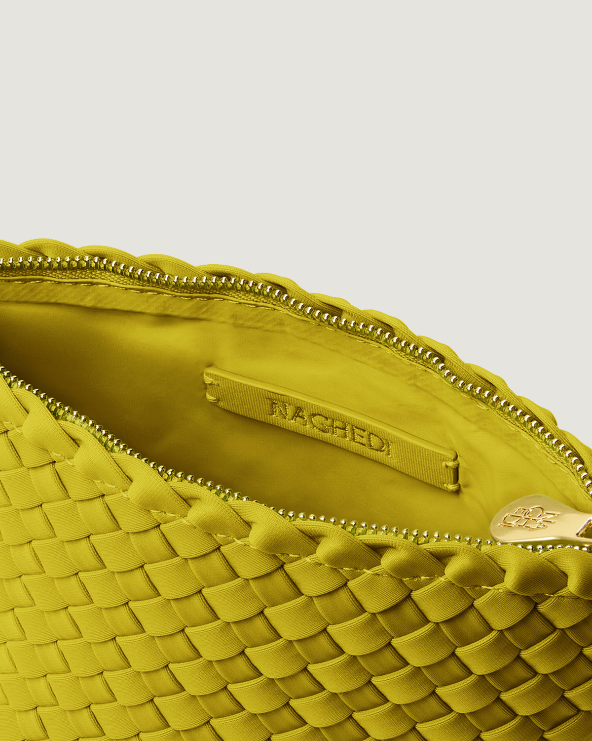 Interior close-up of Portofino Cosmetic Pouch in Ochre showing its zip closure, interior pocket, and wipe-clean nylon interior.