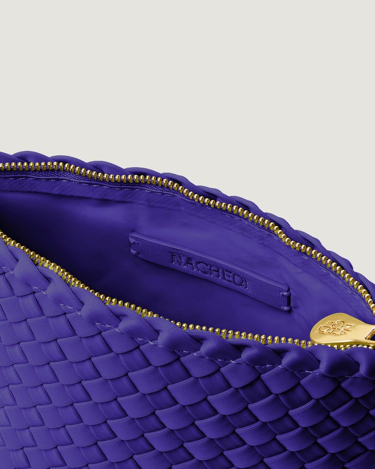Interior close-up of Portofino Cosmetic Pouch in Ultramarine showing its zip closure, interior pocket, and wipe-clean nylon interior.