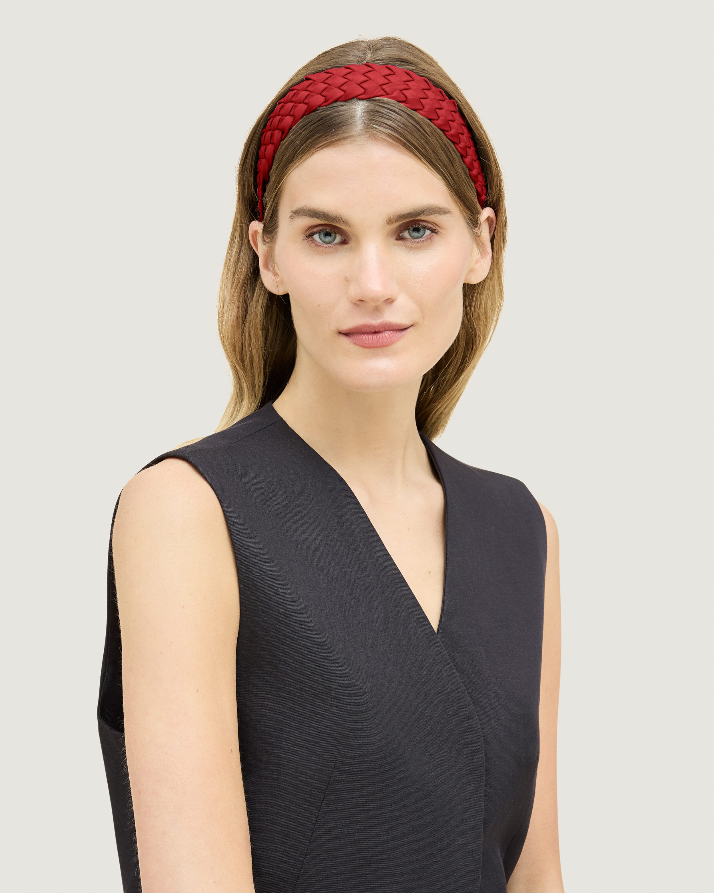 Rivage Headband in Rosso shown on model to illustrate scale and soft silhouette.
