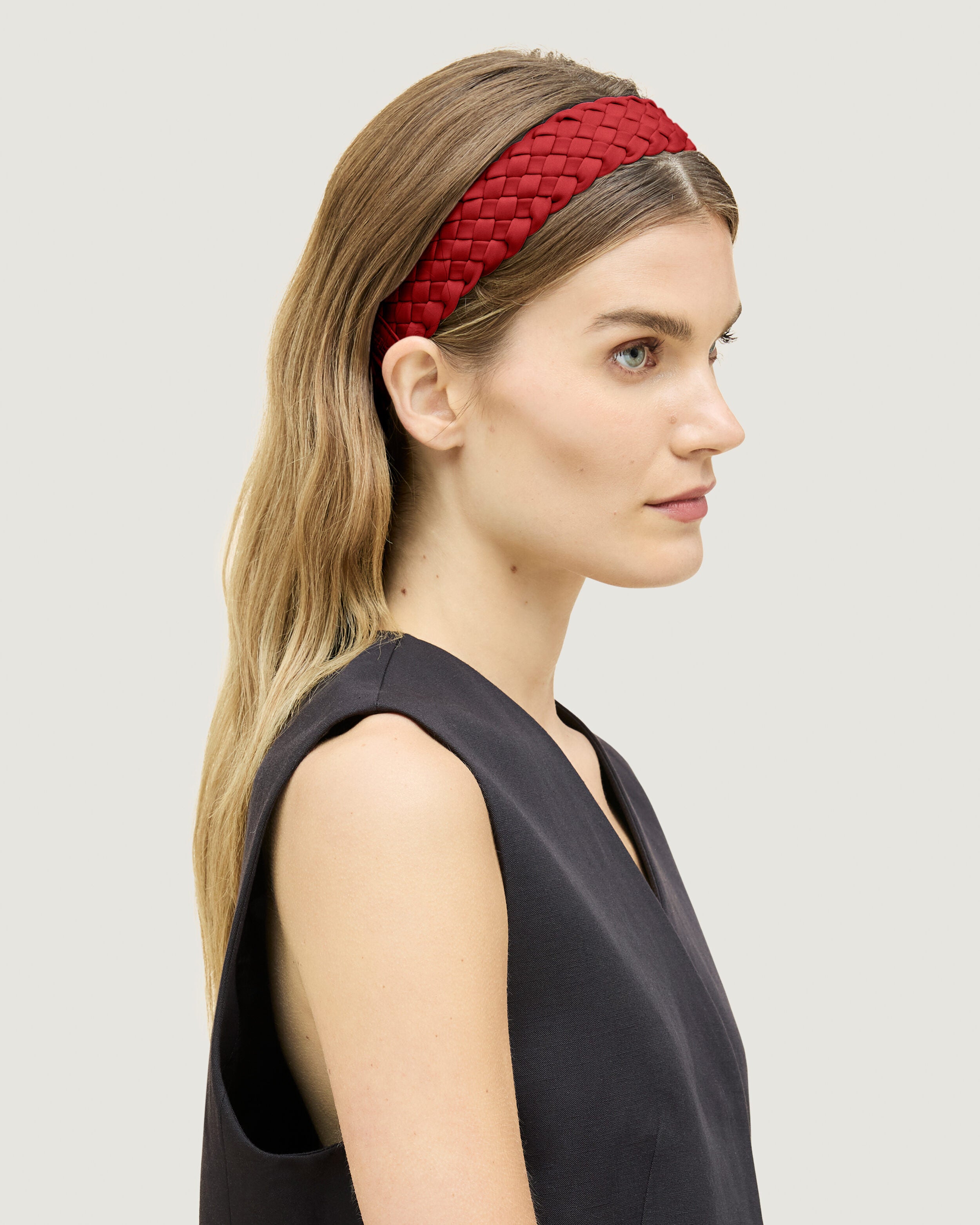 Rivage Headband in Rosso shown on model to illustrate scale and soft silhouette.