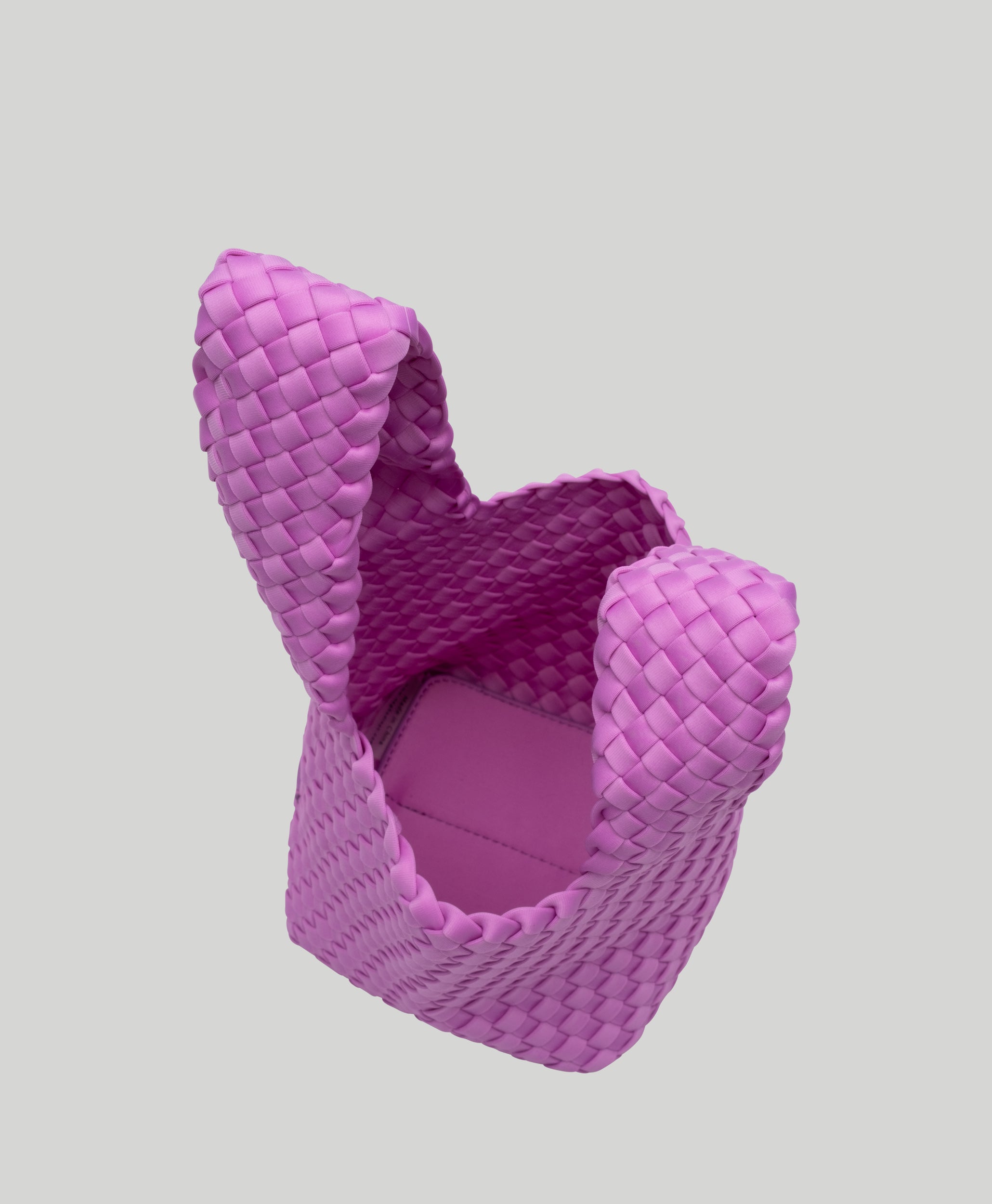 Interior close-up of Kyoto Clutch in Orchid showing its secure slide-through loop closure, and unlined interior.