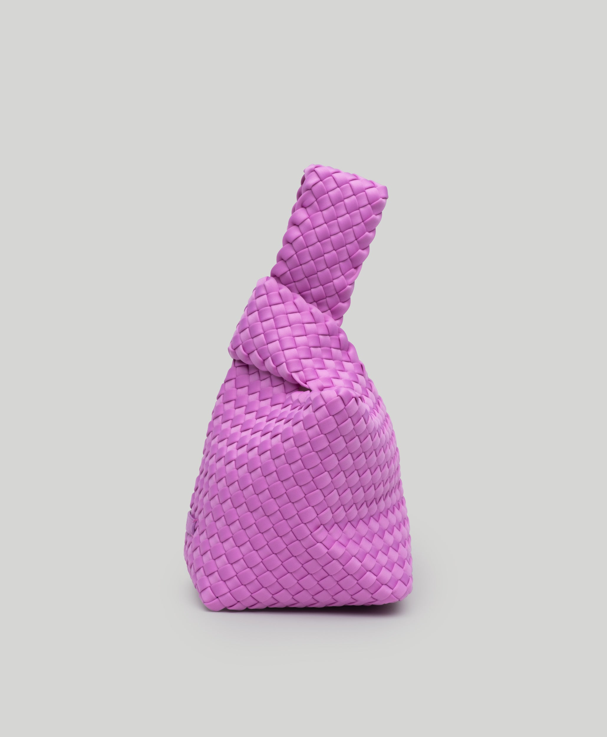 Kyoto Clutch in Orchid, a light purple tone, in handwoven neoprene, featuring a secure slide-through loop closure.