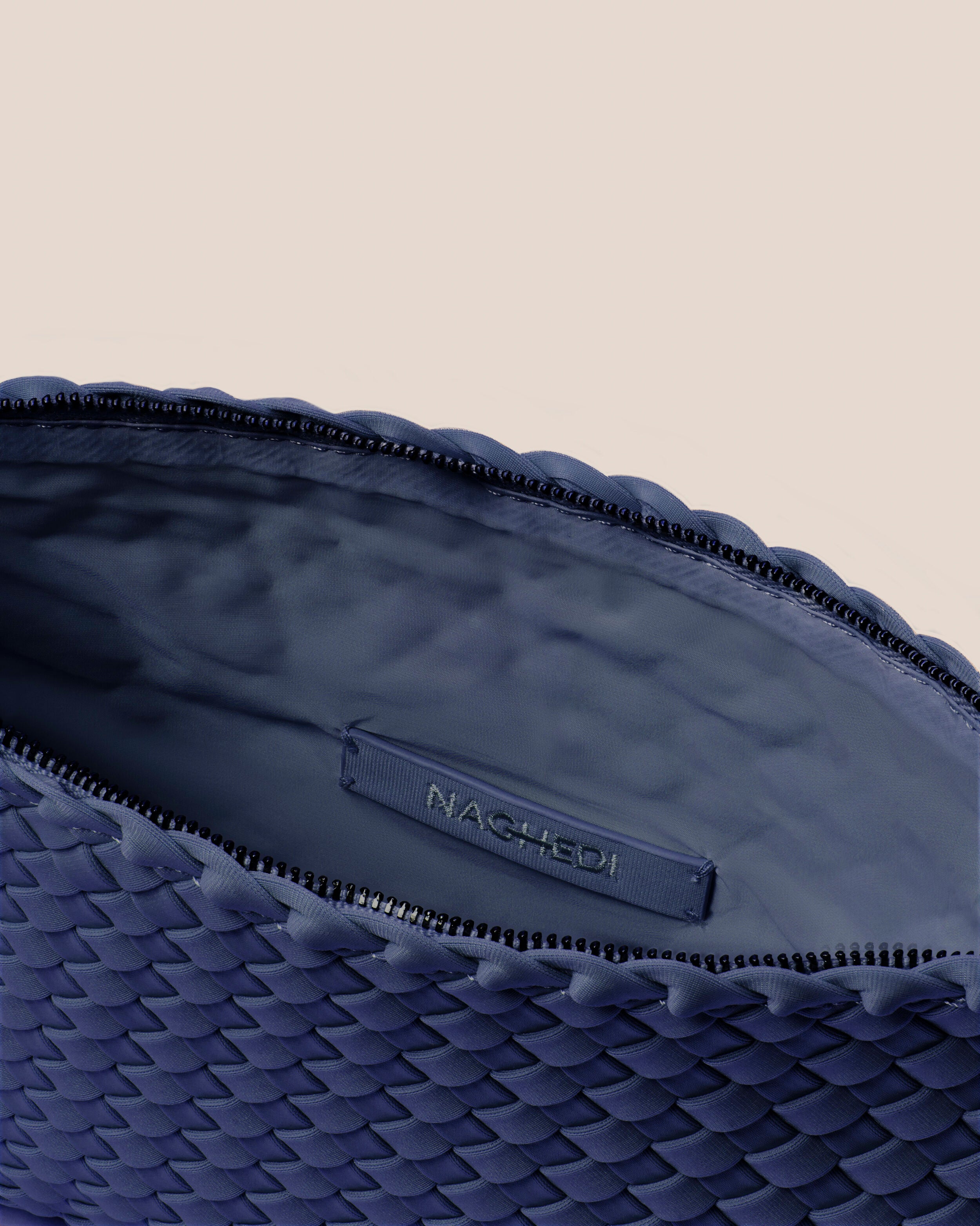 Interior close-up of Salina Pouch in Ink Blue showing its zip closure, and wipe-clean nylon interior.