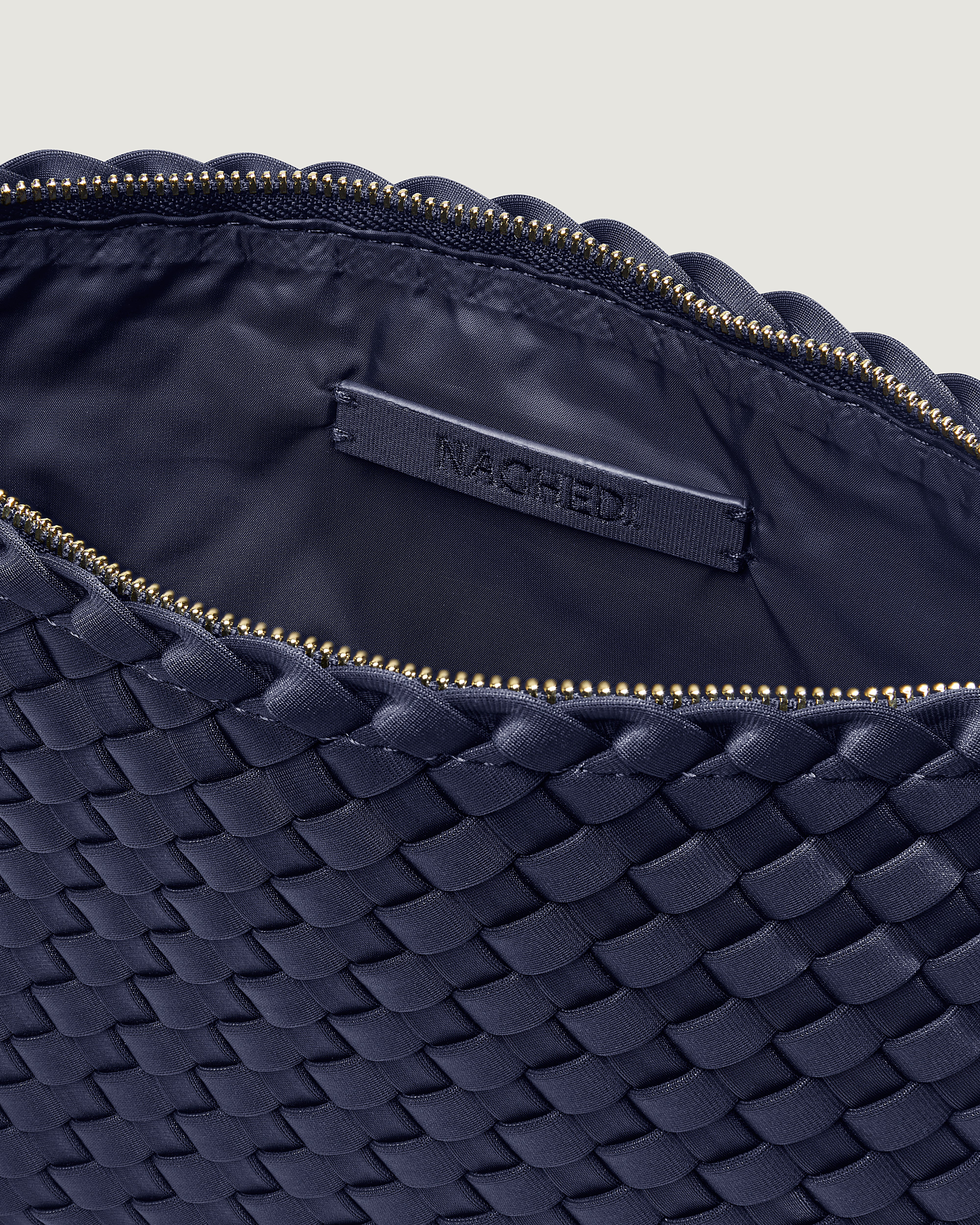 Interior close-up of Salina Pouch in Ink Blue showing its zip closure, and wipe-clean nylon interior.