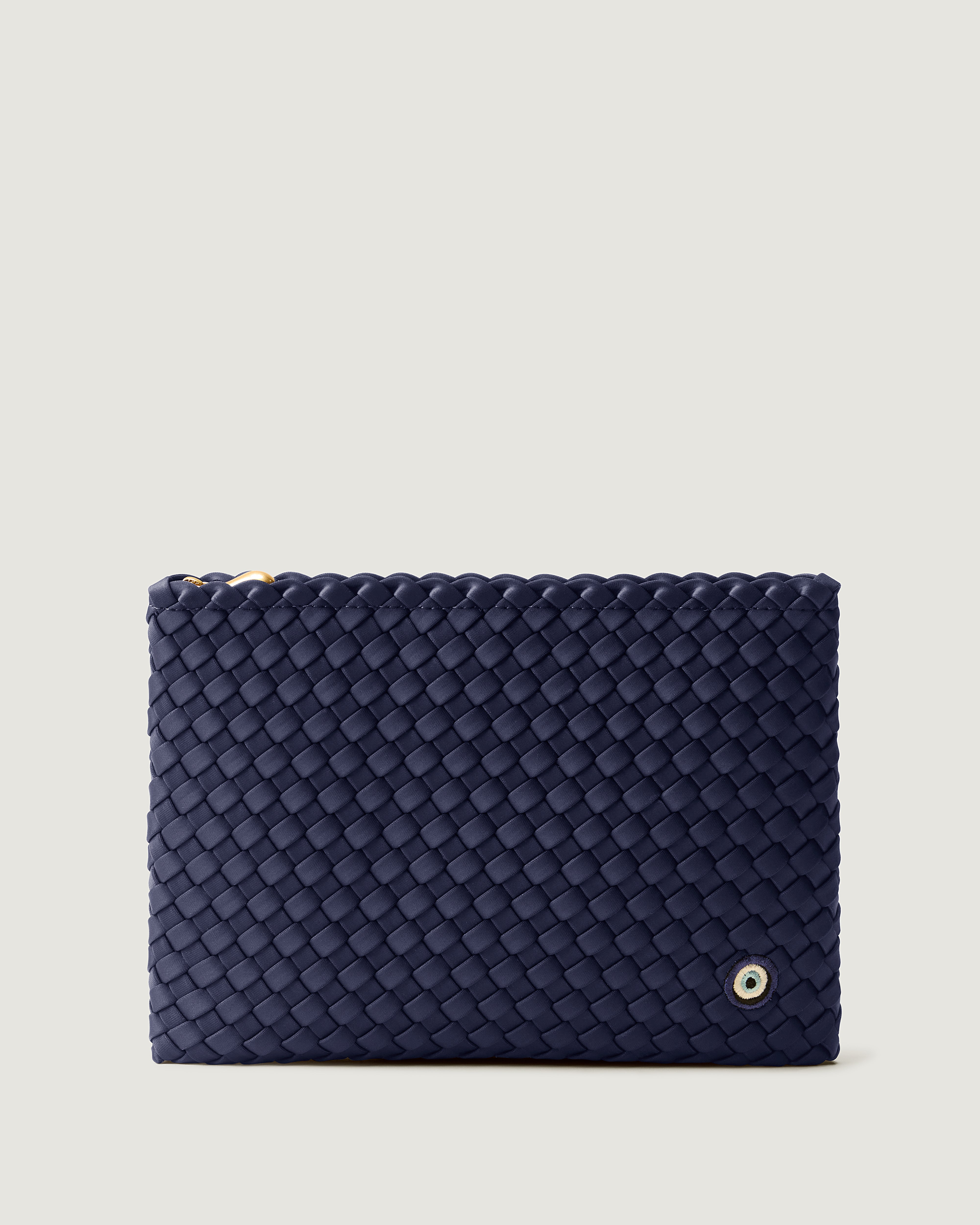 Salina Pouch in Ink Blue, a navy blue tone, in handwoven neoprene, featuring a zip closure and Evil Eye embroidery.