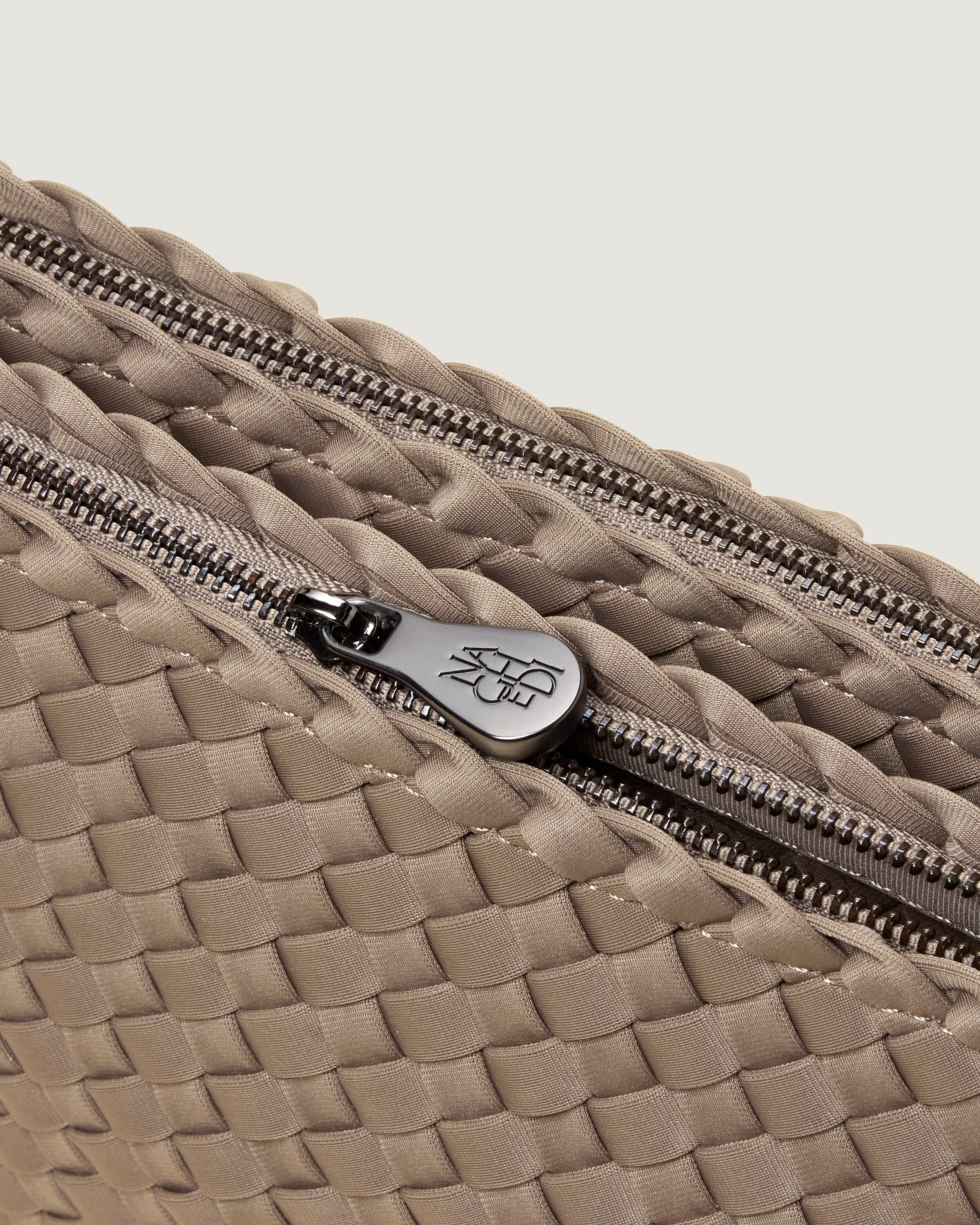 Interior close-up of Soho Envelope in Cashmere showing its dual zip top closure, and unlined interior.