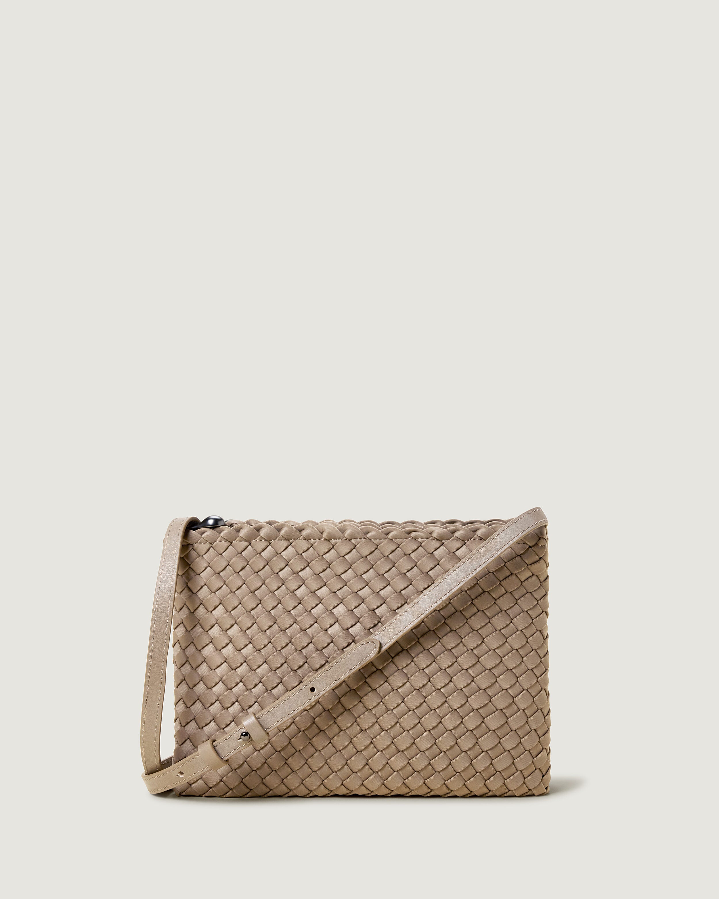 Soho Envelope in Cashmere, a taupe tone, in handwoven neoprene, featuring a dual zip top closure, and adjustable leather crossbody strap.