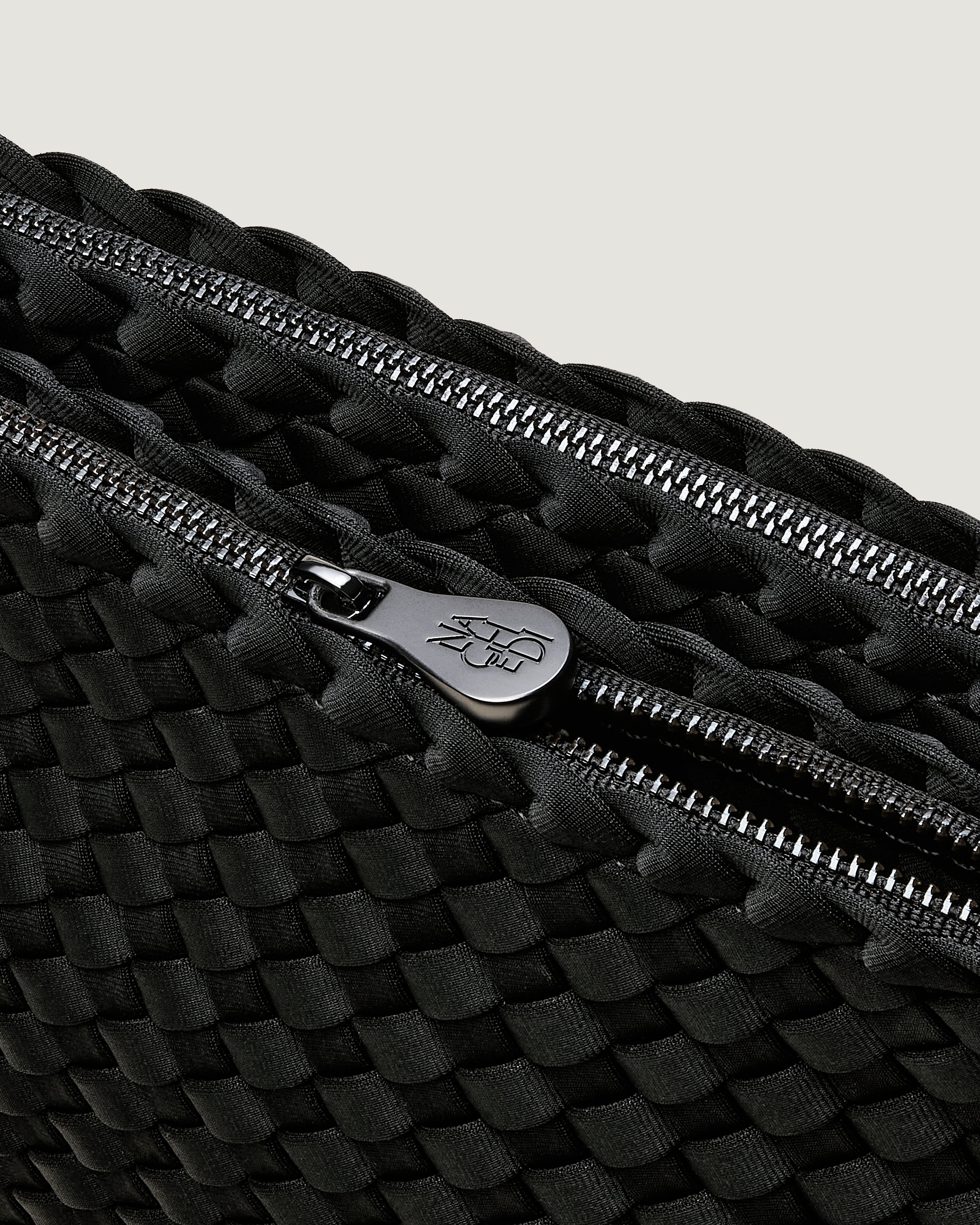 Interior close-up of Soho Envelope in Onyx showing its dual zip top closure, and unlined interior.