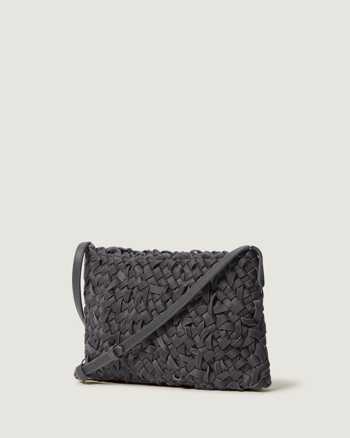 Side view of handwoven neoprene crossbody bag in ash gray color in a crosshatch nest weave pattern.
