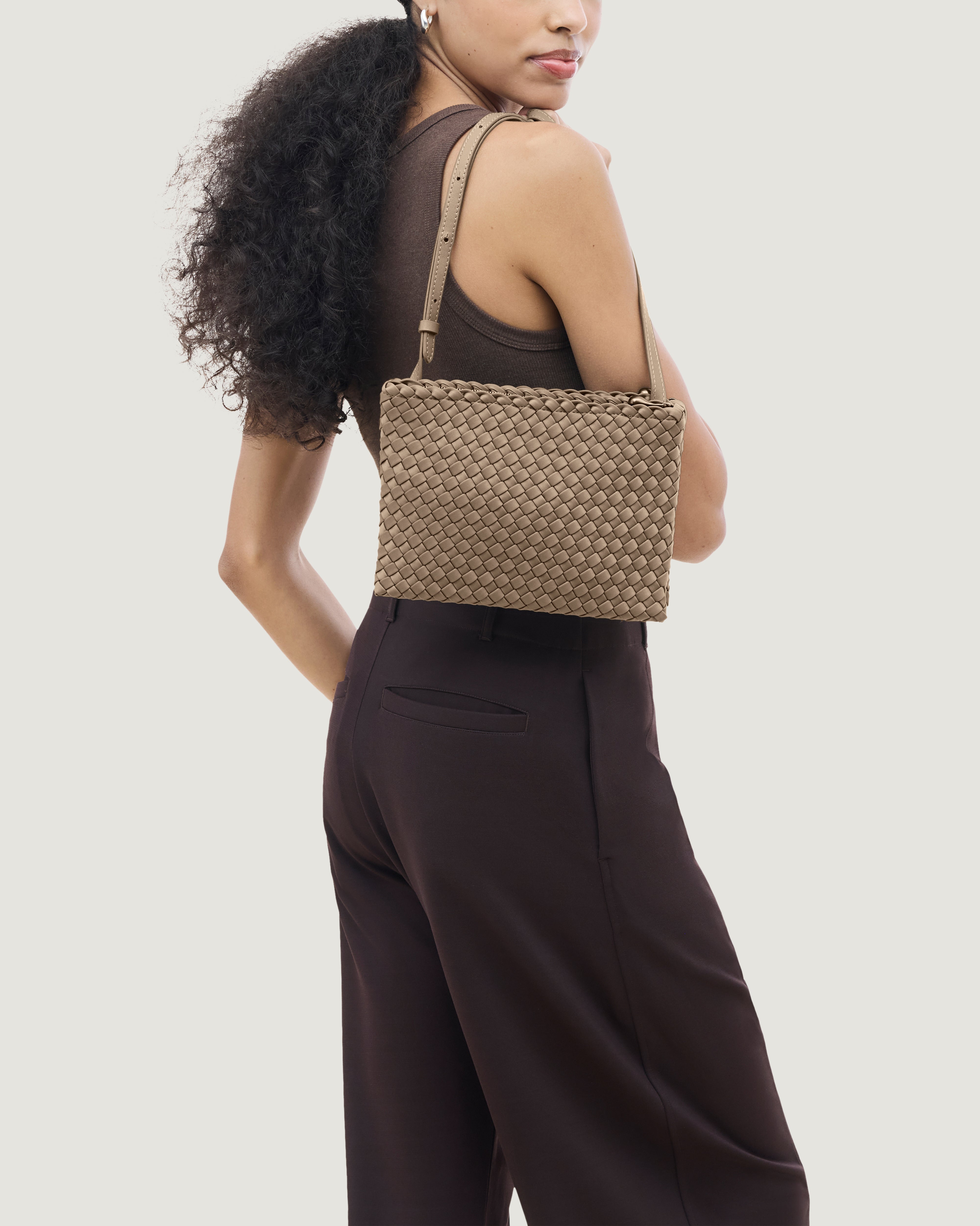 Soho Envelope Crossbody in Cashmere shown on model to illustrate scale and soft silhouette.