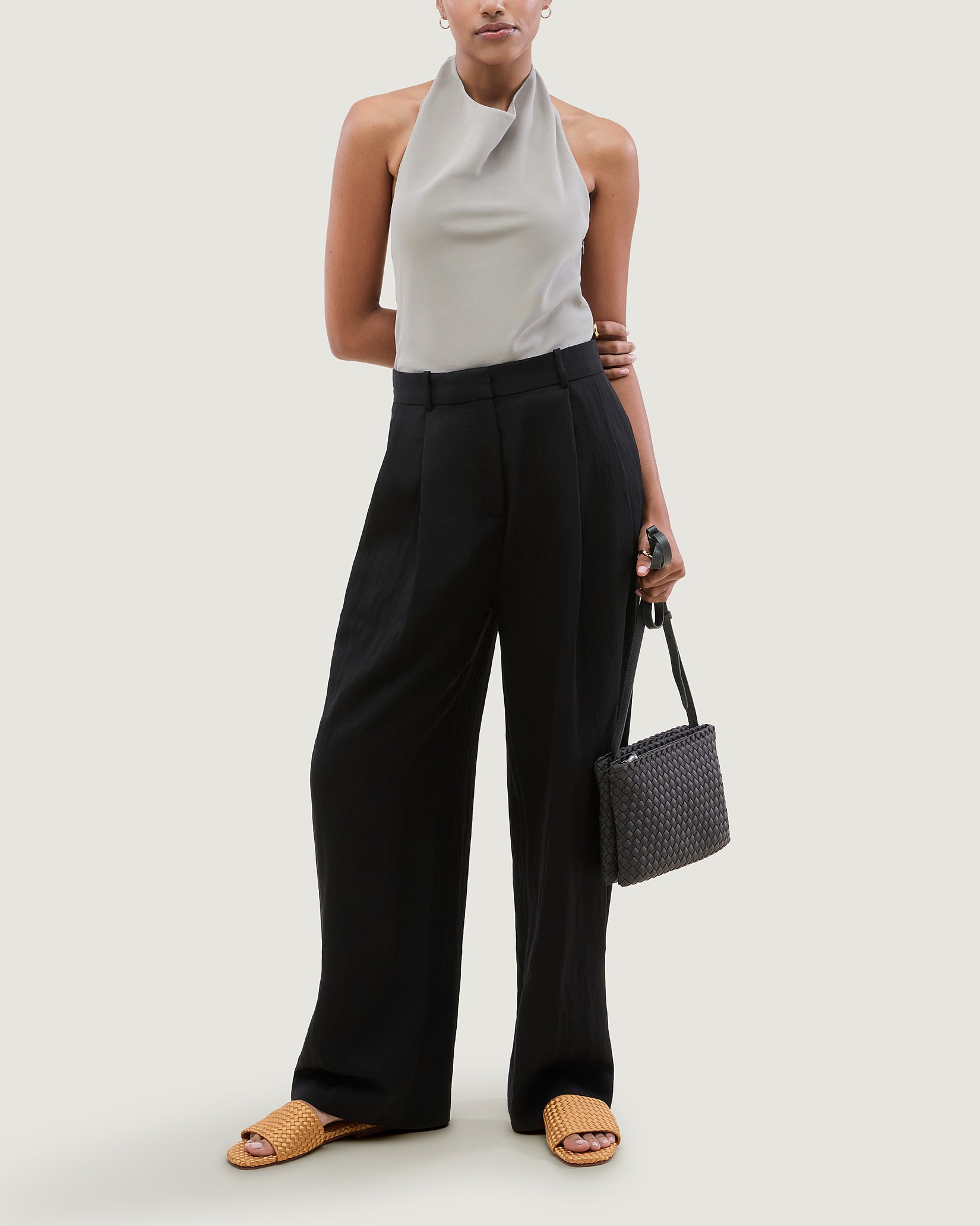 Soho Medium Envelope Crossbody in Ash shown on model to illustrate scale and soft silhouette.