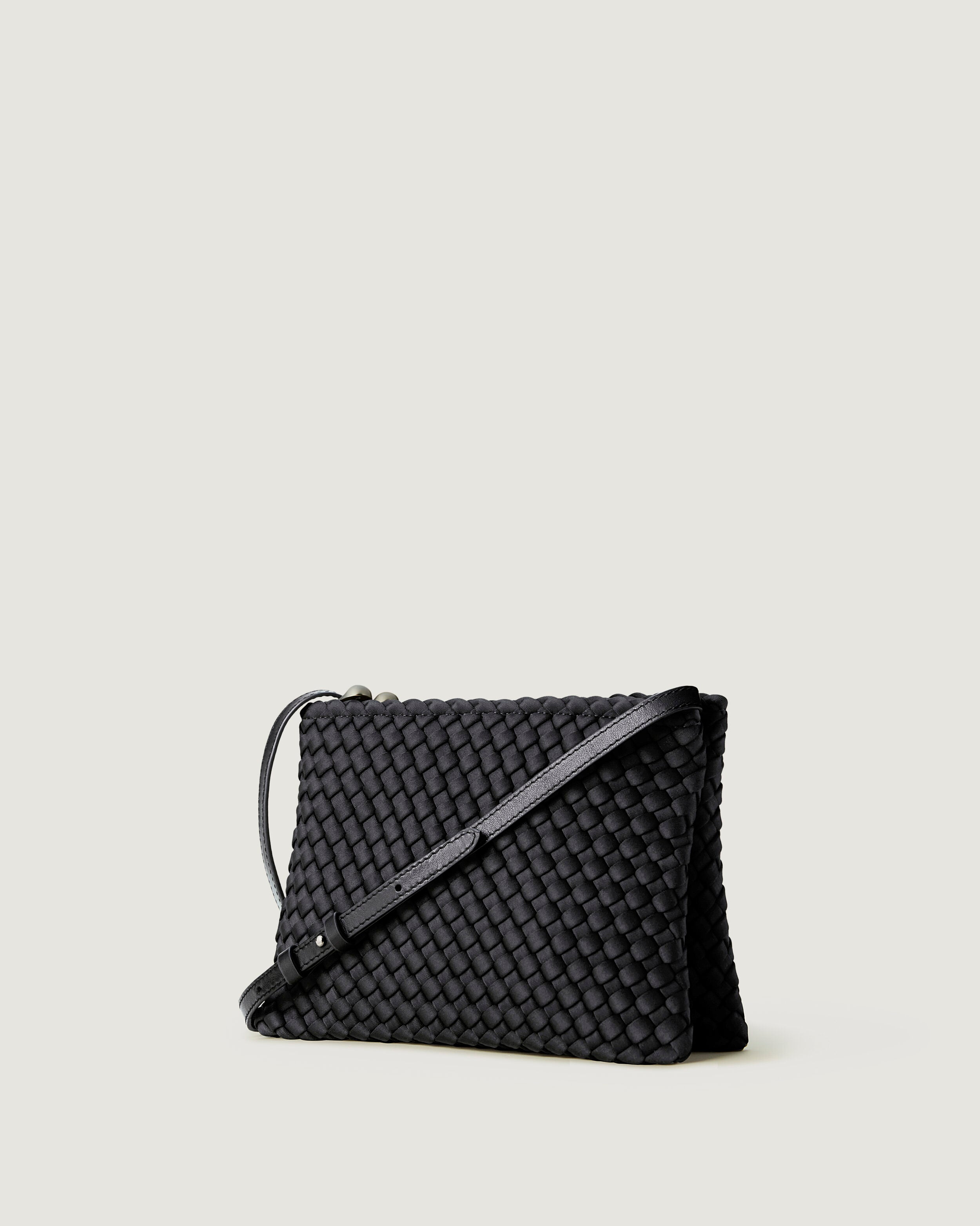 Soho Envelope in Ash shown from a side angle, highlighting its handwoven neoprene construction and dual zip top closure.