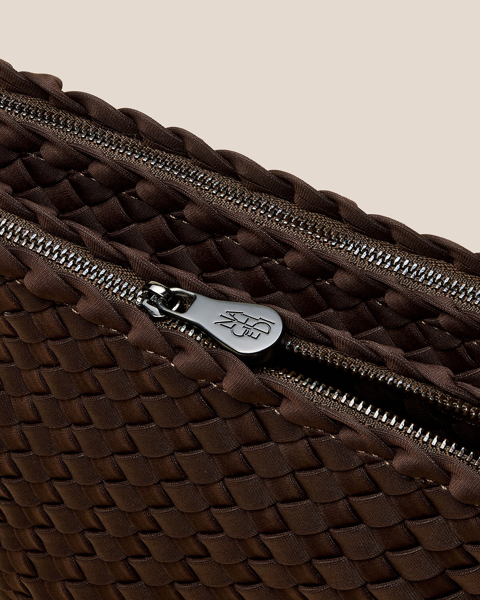 Interior close-up of Soho Medium Envelope Crossbody in Chocolate showing its dual zip top closure, and unlined interior.