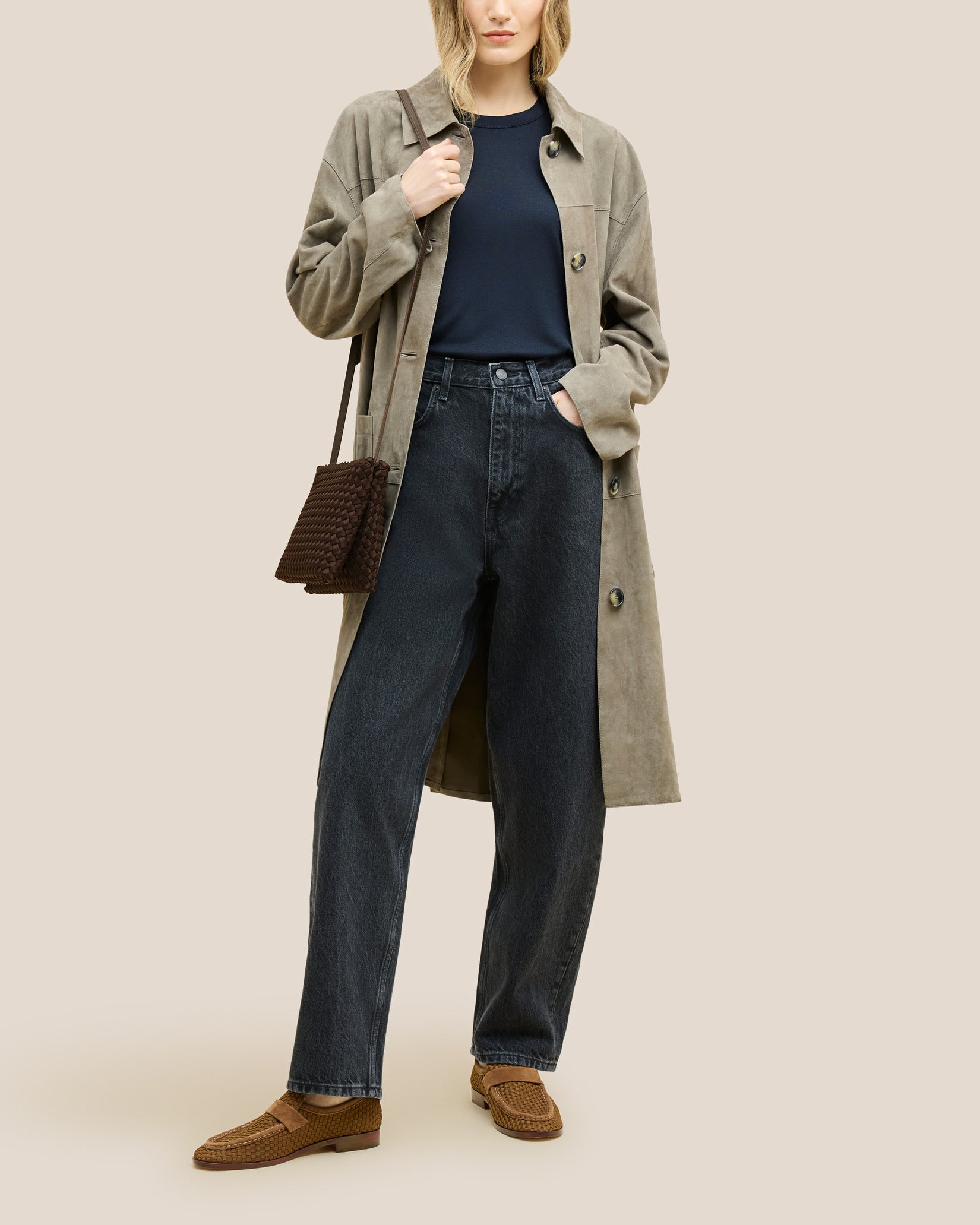 Soho Medium Envelope Crossbody in Chocolate shown on model to illustrate scale and soft silhouette.