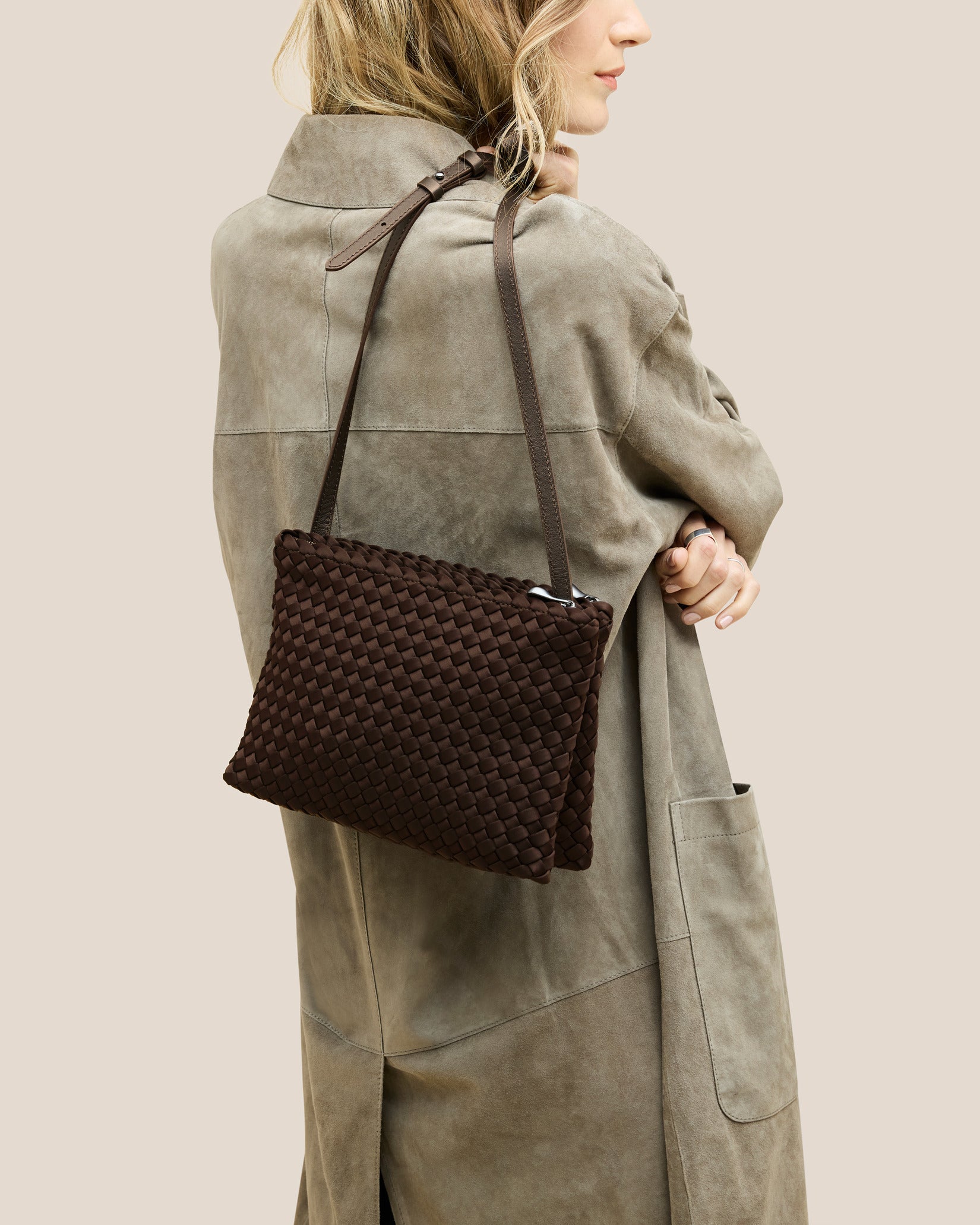 Soho Medium Envelope Crossbody in Chocolate shown on model to illustrate scale and soft silhouette.