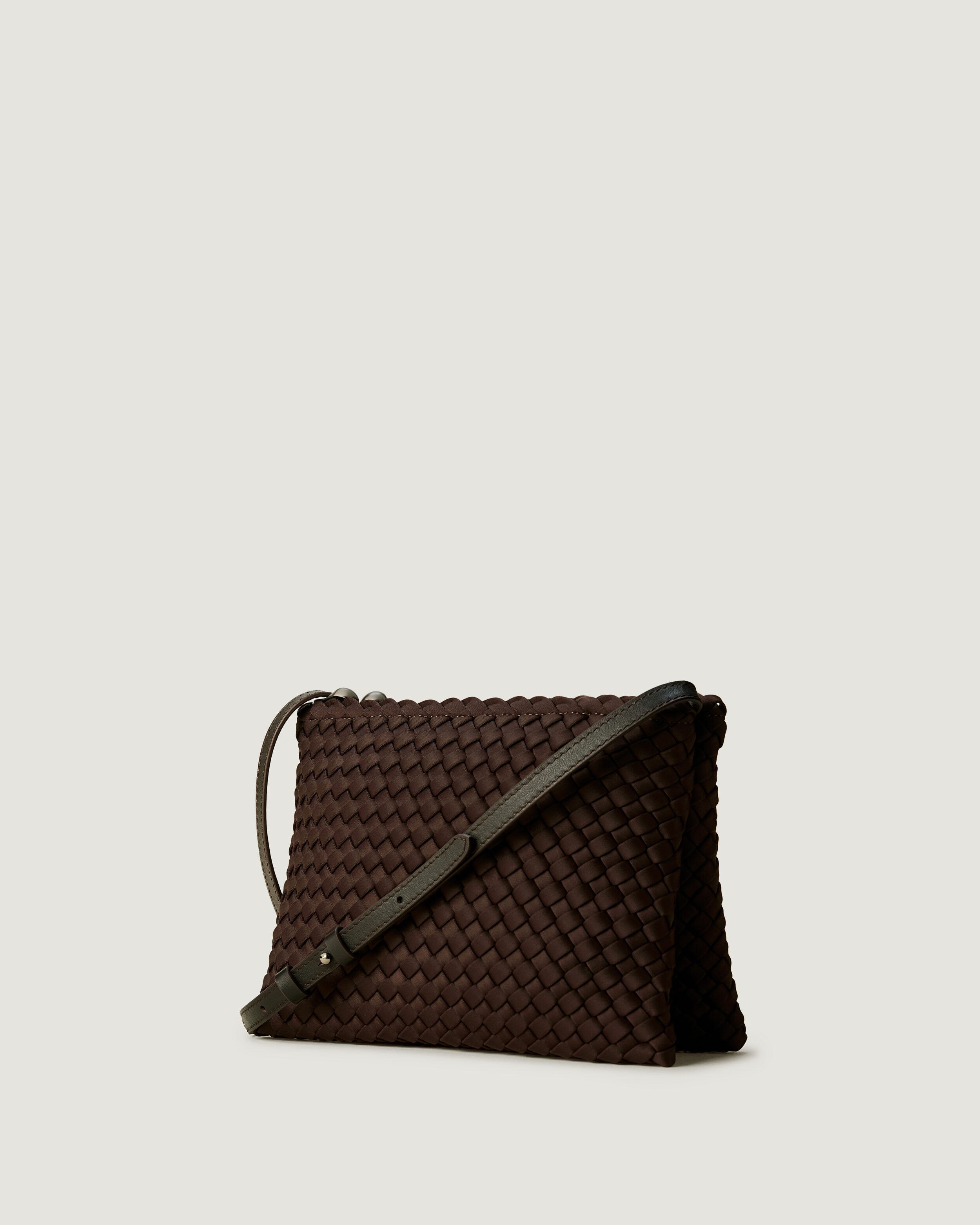 Soho Envelope in Chocolate shown from a side angle, highlighting its handwoven neoprene construction and dual zip top closure.