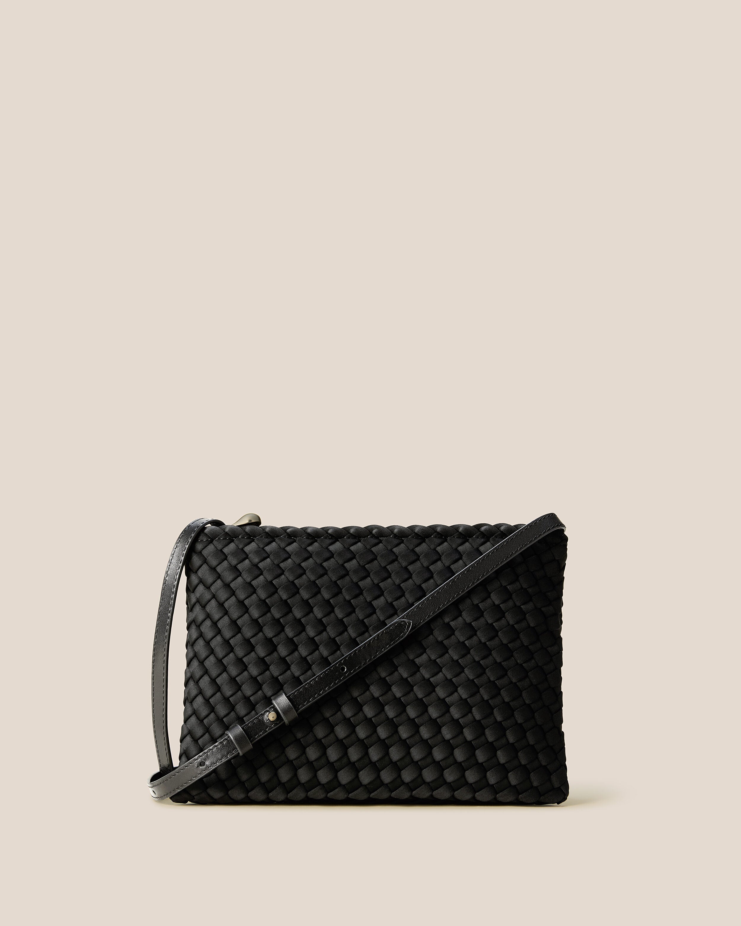 Soho Envelope in Onyx, a true black tone, in handwoven neoprene, featuring a dual zip top closure, and adjustable leather crossbody strap.