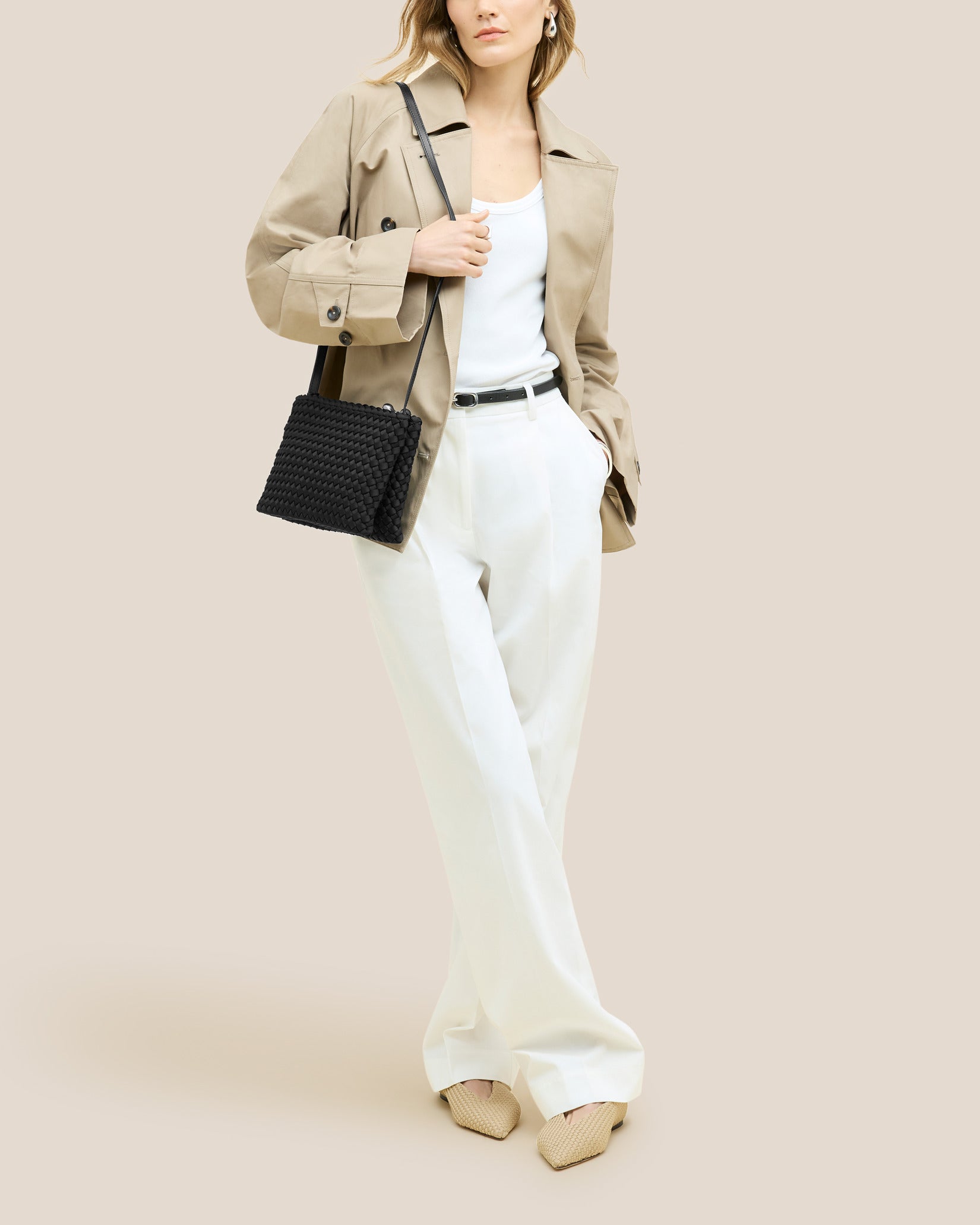 Soho Medium Envelope Crossbody in Onyx shown on model to illustrate scale and soft silhouette.