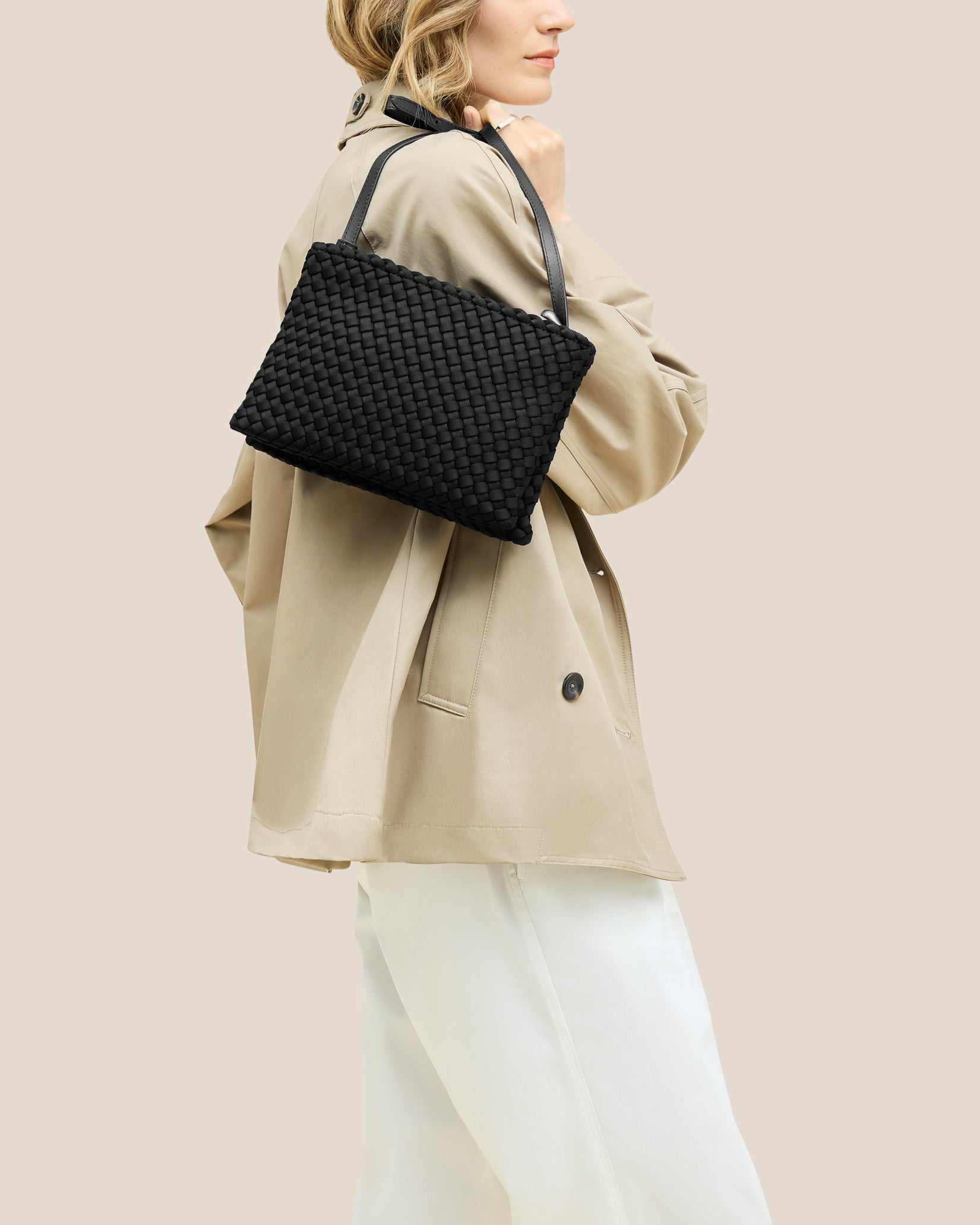 Soho Medium Envelope Crossbody in Onyx shown on model to illustrate scale and soft silhouette.