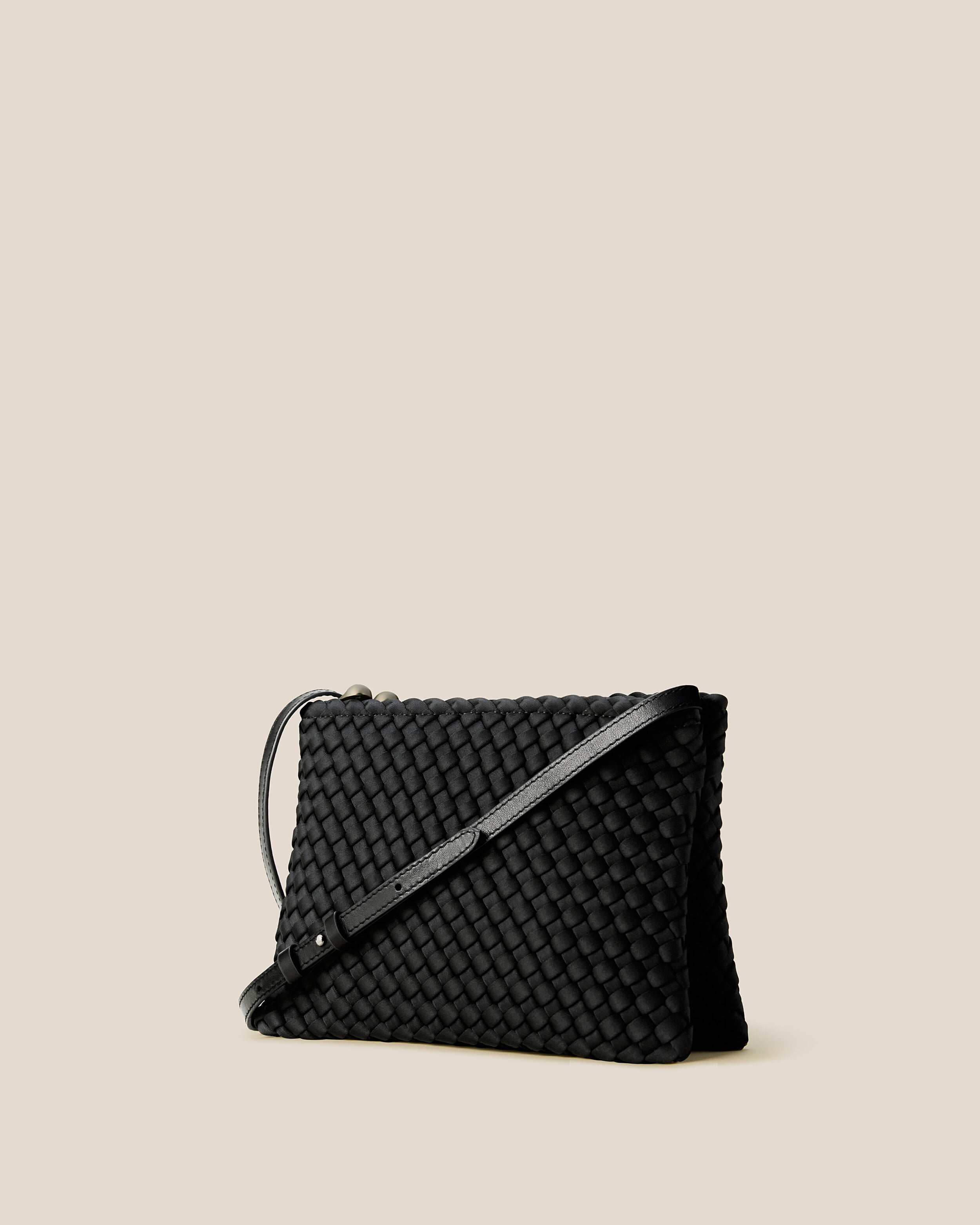 Soho Envelope in Onyx shown from a side angle, highlighting its handwoven neoprene construction and dual zip top closure.