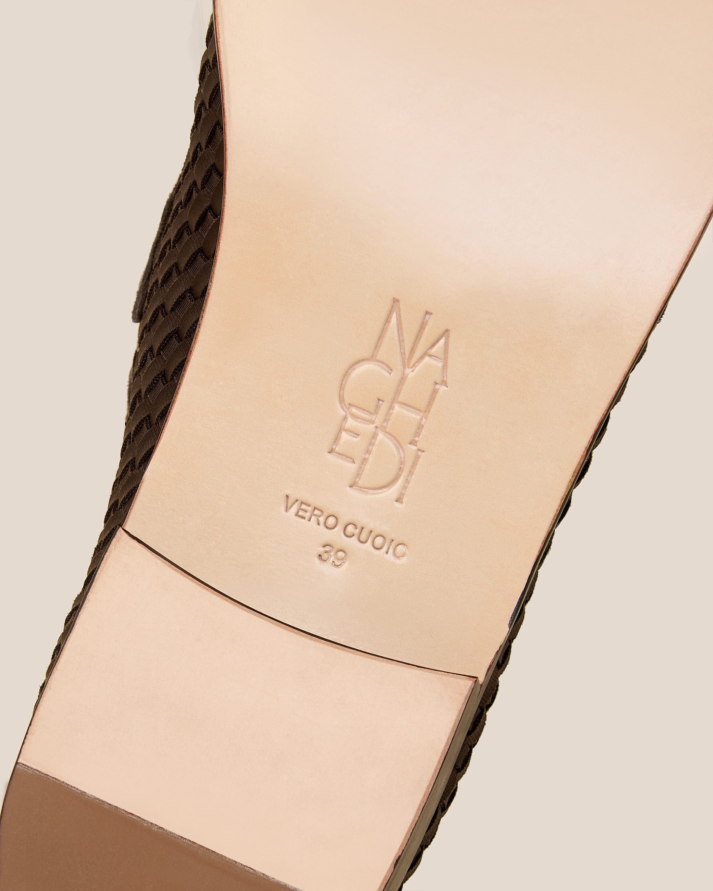 Shoe sole showing stamped NAGHEDI logo and size detail for The Sonoma Loafer in Chocolate.