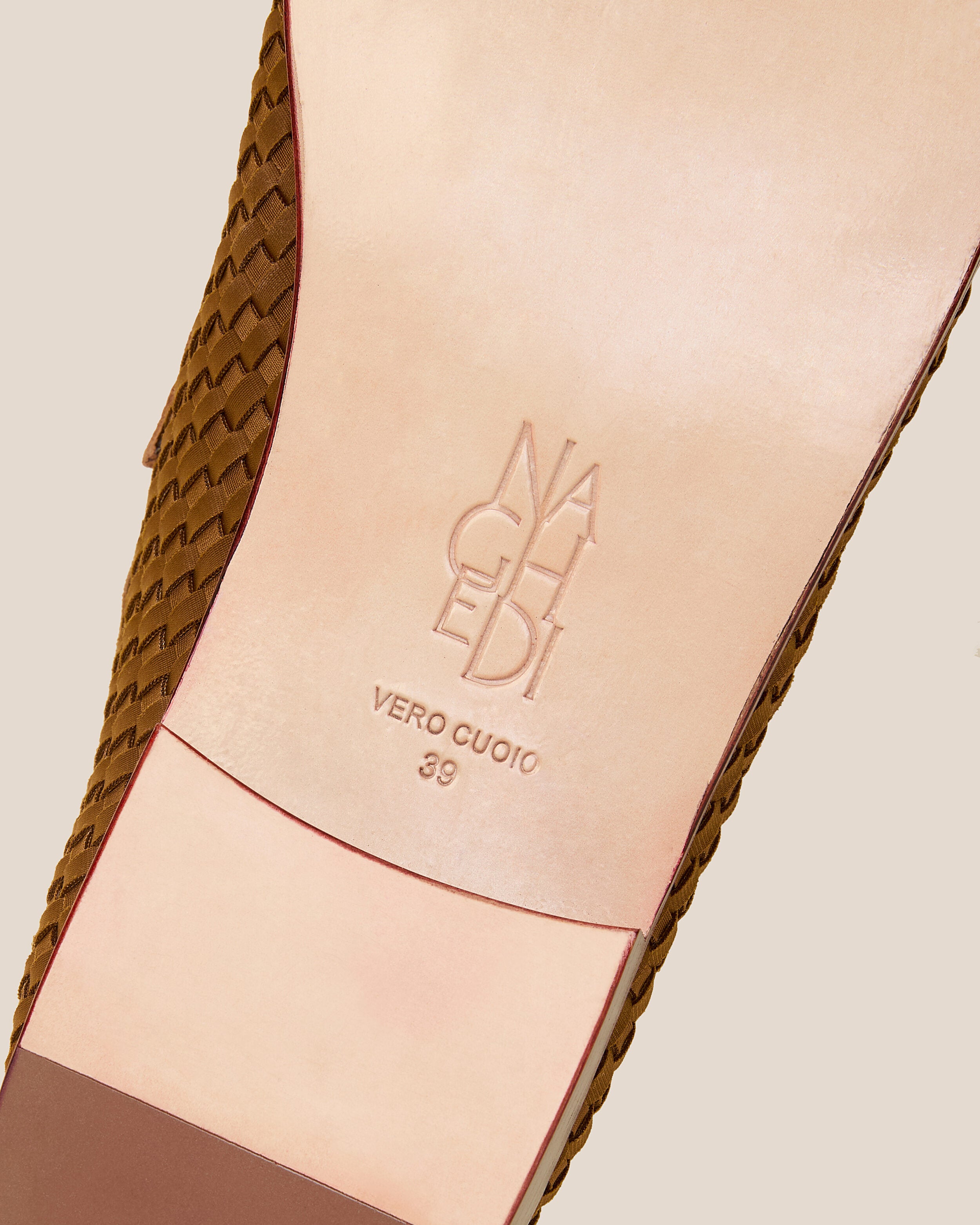Shoe sole showing stamped NAGHEDI logo and size detail for The Sonoma Loafer in Teak.