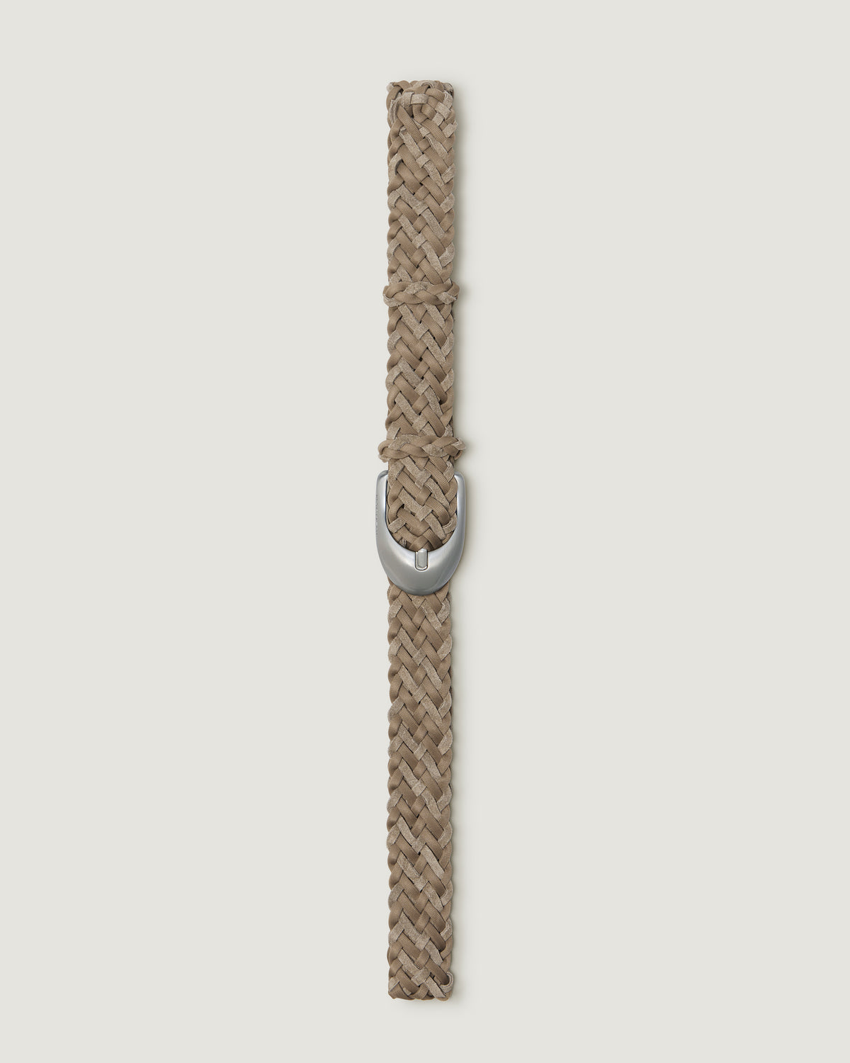 A vertical view of a handwoven cool taupe suede and neoprene belt with a polished silver buckle.
