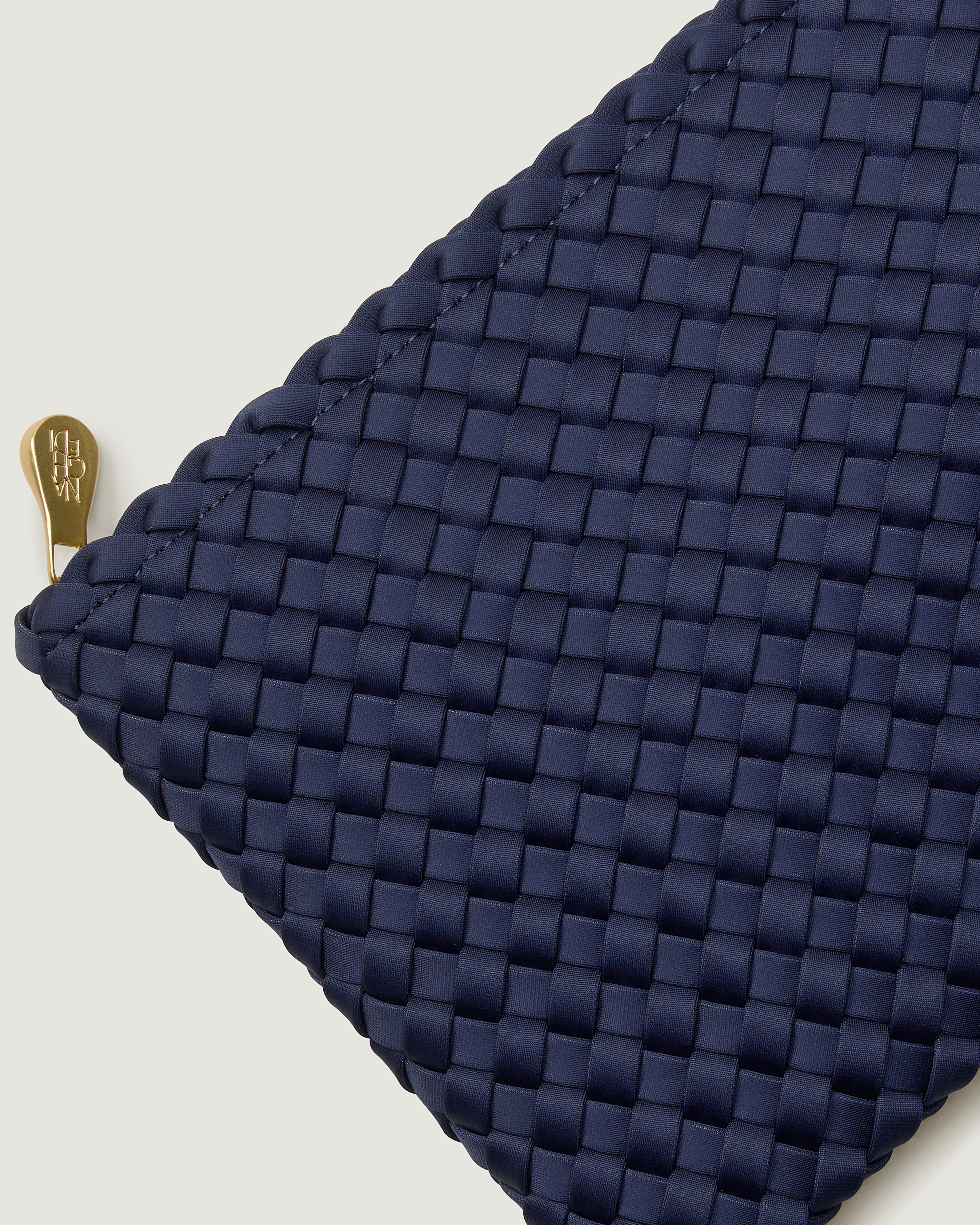Close-up of included matching woven zippered pouch.