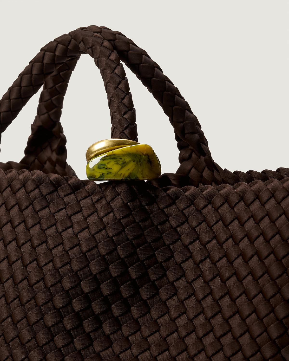 Close up of the St Barths Tote in Chocolate highlighting the two beads on the handle.
