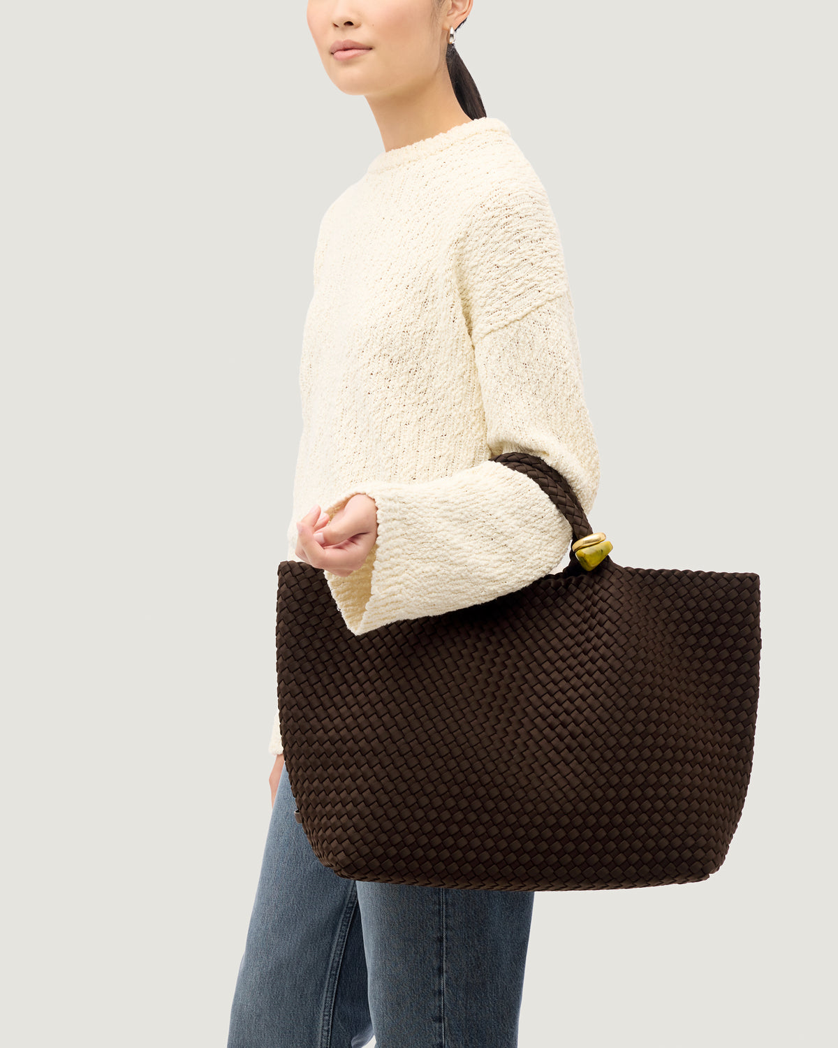 St. Barths Tote in Chocolate shown on model to illustrate scale and soft silhouette.