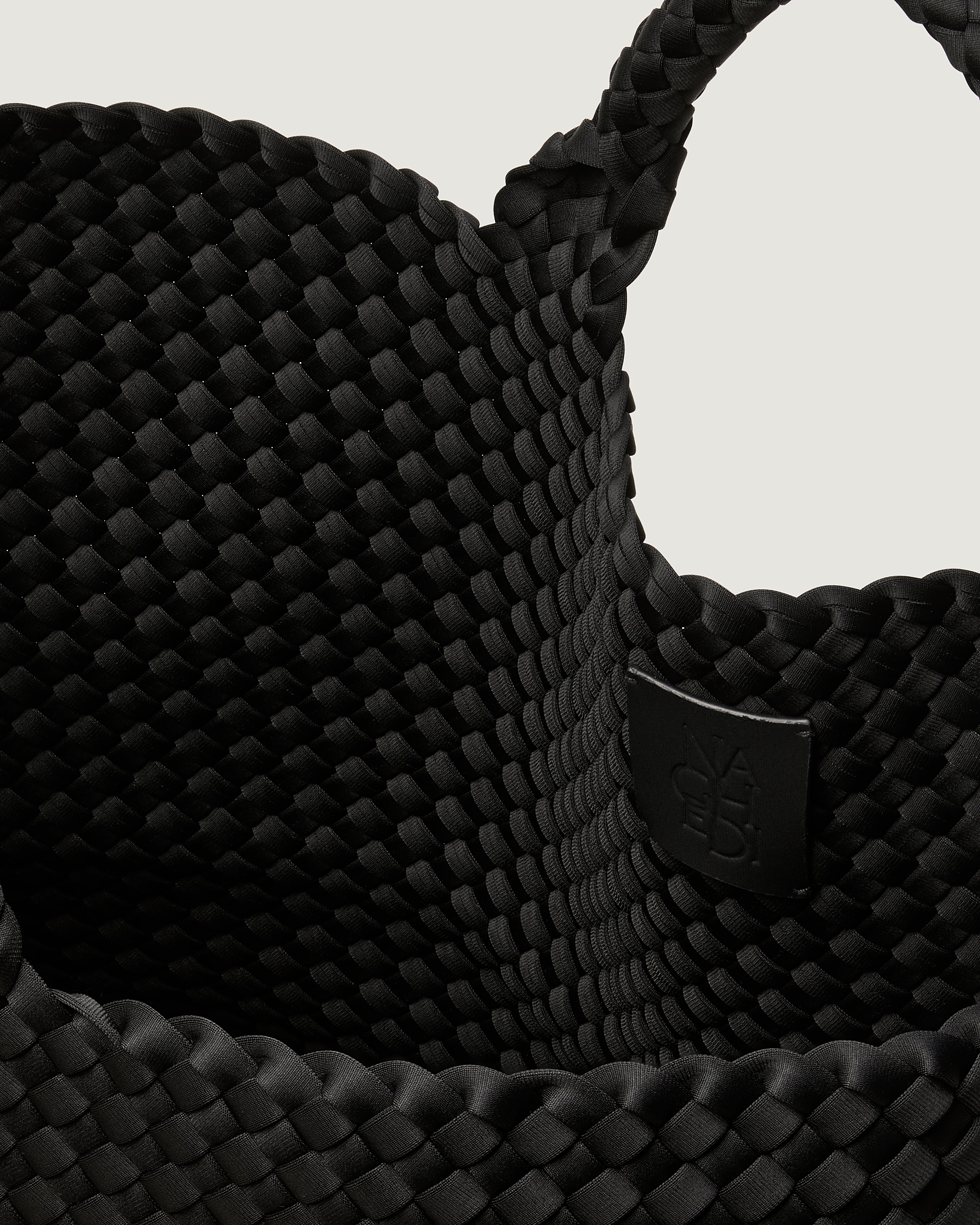 Interior close-up of St. Barths Tote in Onyx showing its open top, and unlined interior.