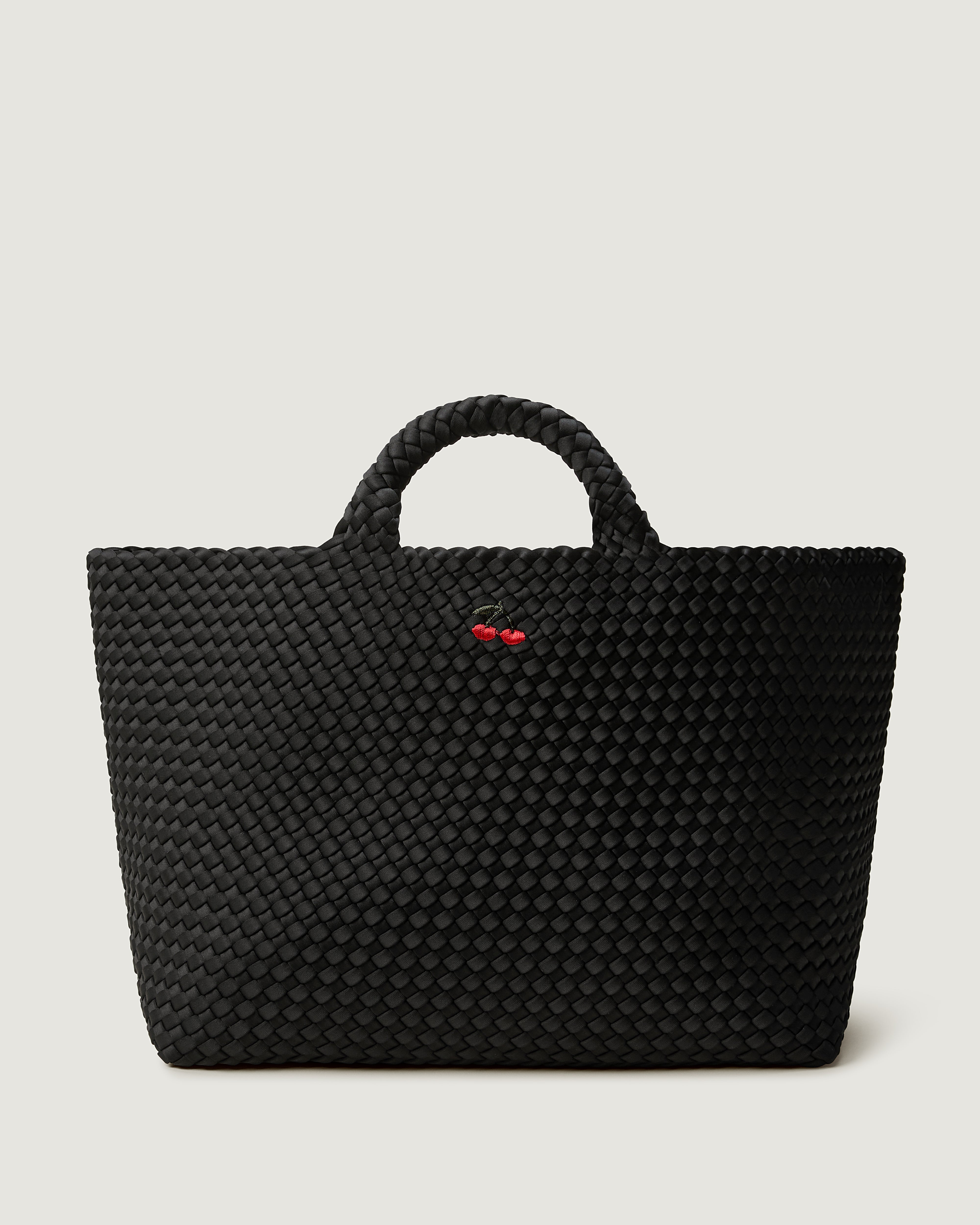 St. Barths Tote in Onyx, a true black tone, in handwoven neoprene, featuring an open top, woven top handles and cherry embroidery. 