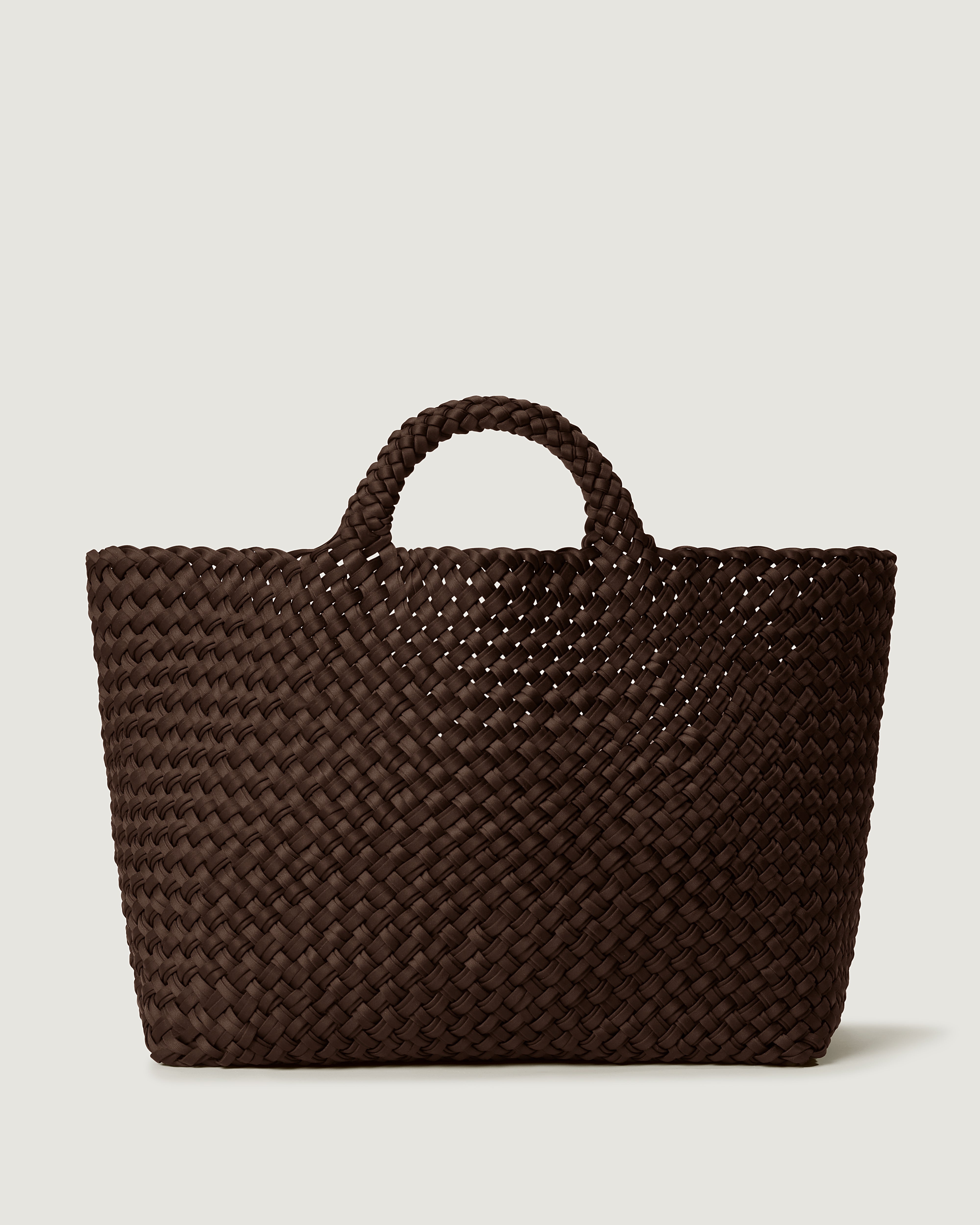 St. Barths Tote in Chocolate, handwoven from doubled strands of dark drown neoprene. Featuring an open top and woven handles.