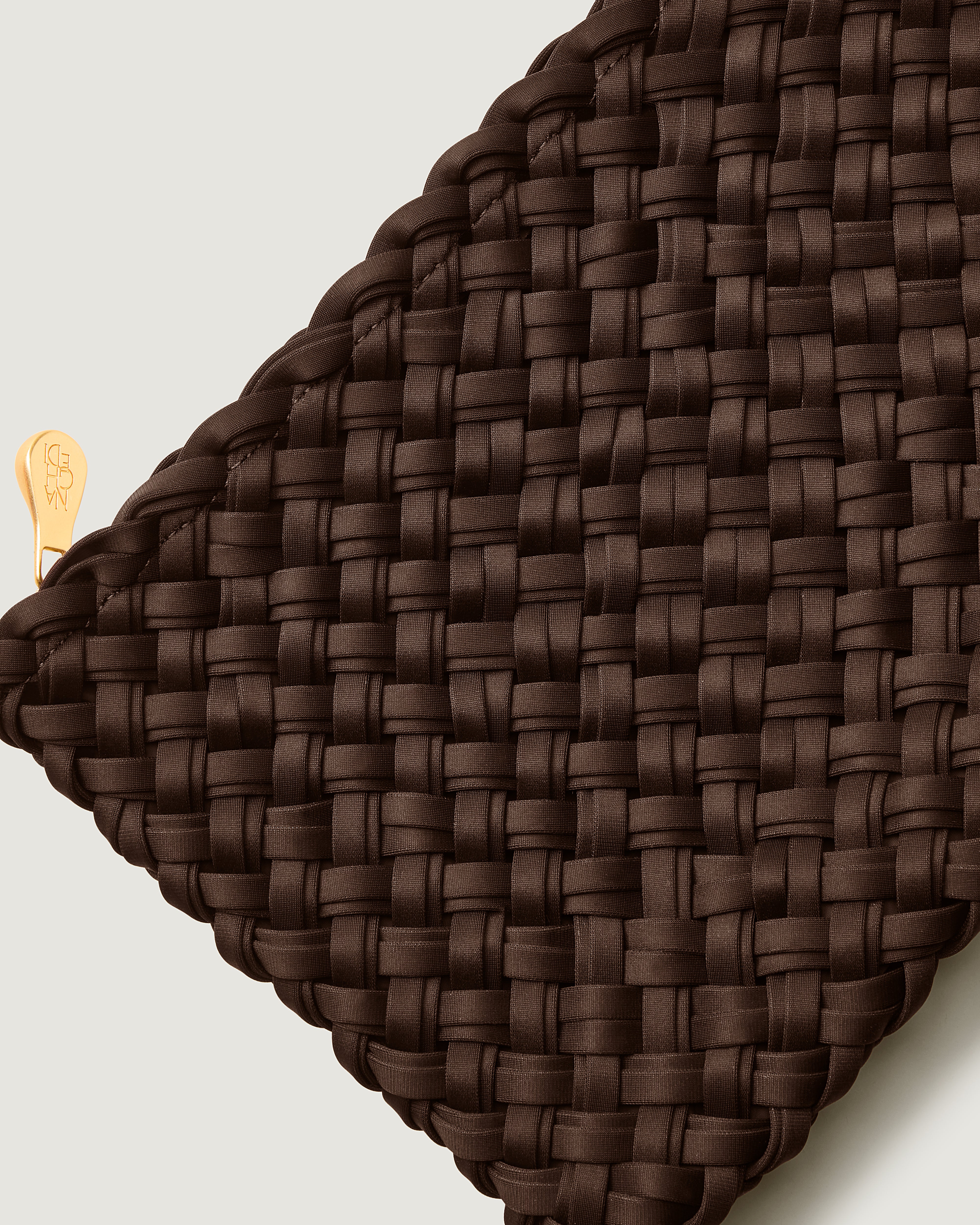 Close-up of included matching woven zippered pouch.