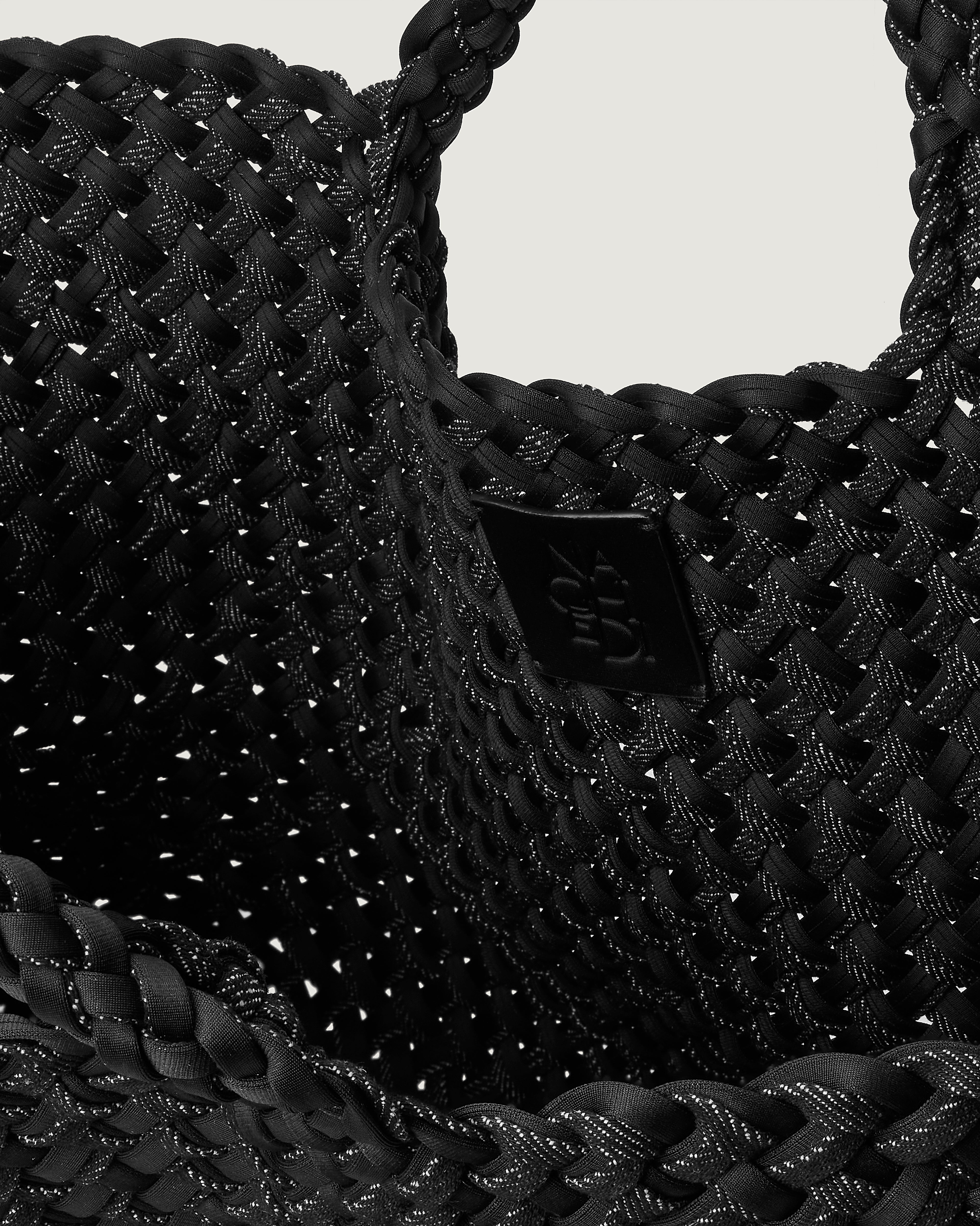 Interior close-up of St. Barths Tote in Jet showing its open top, and unlined interior.