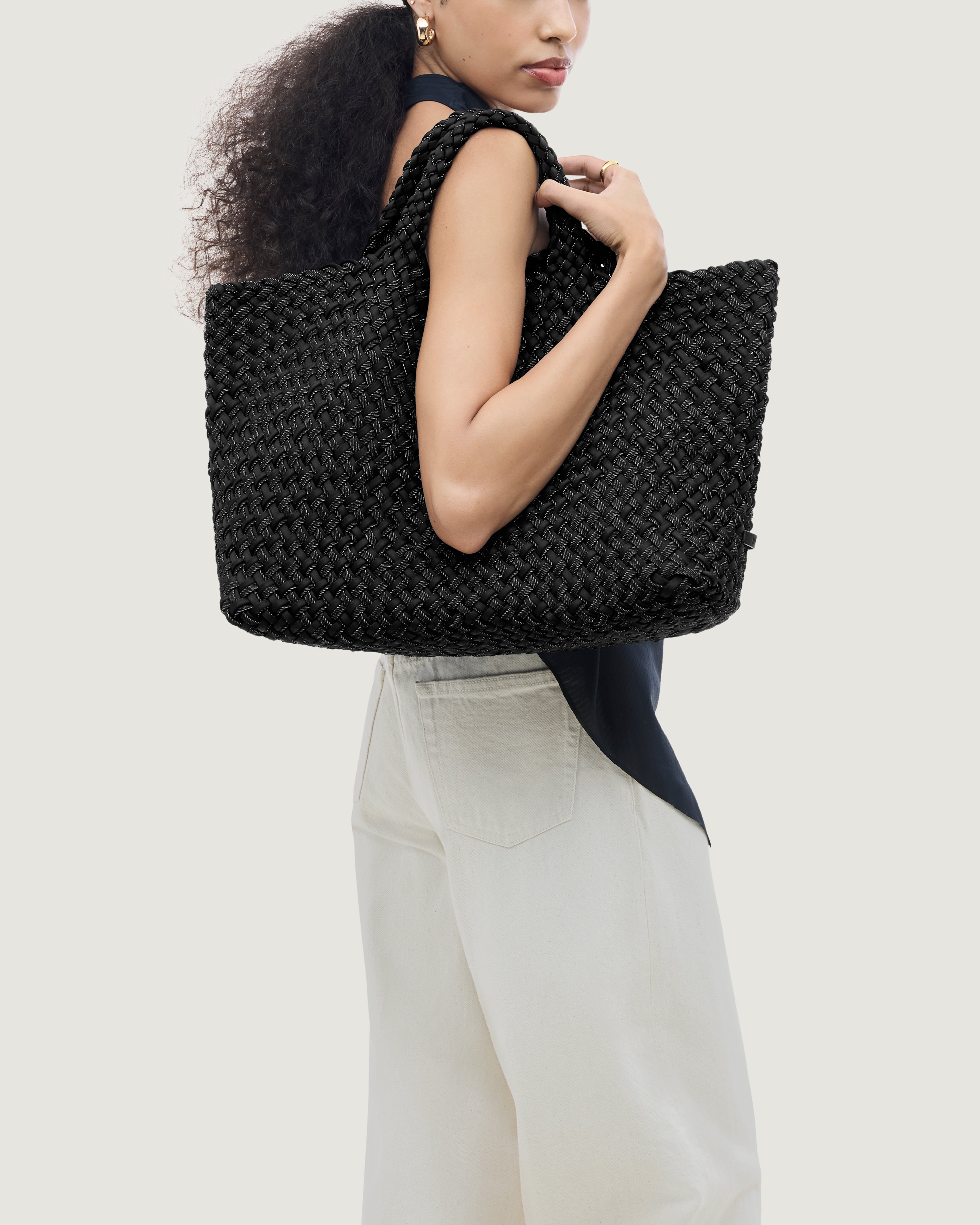 St. Barths Tote in Jet shown on model to illustrate scale and soft silhouette.