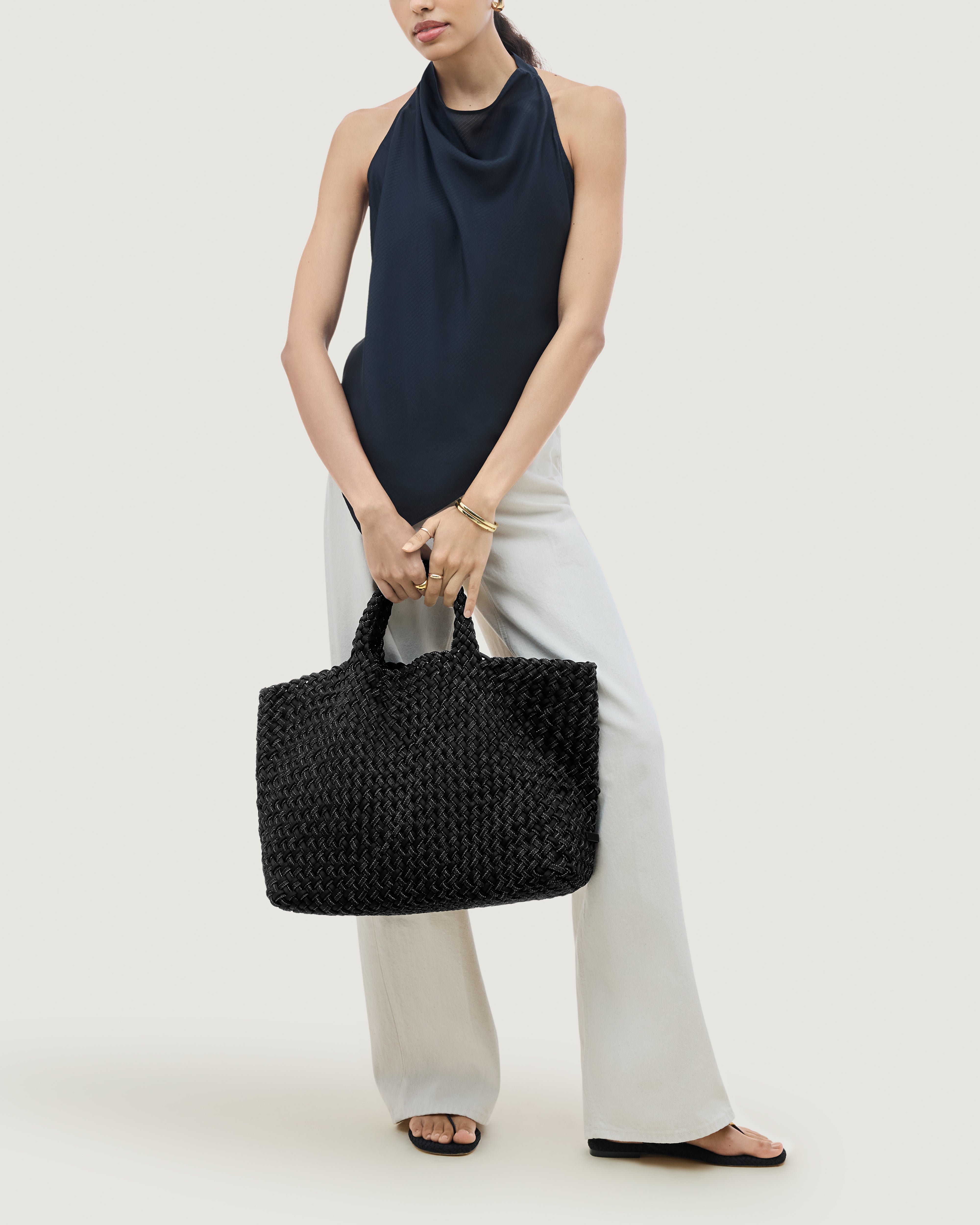 St. Barths Tote in Jet shown on model to illustrate scale and soft silhouette.