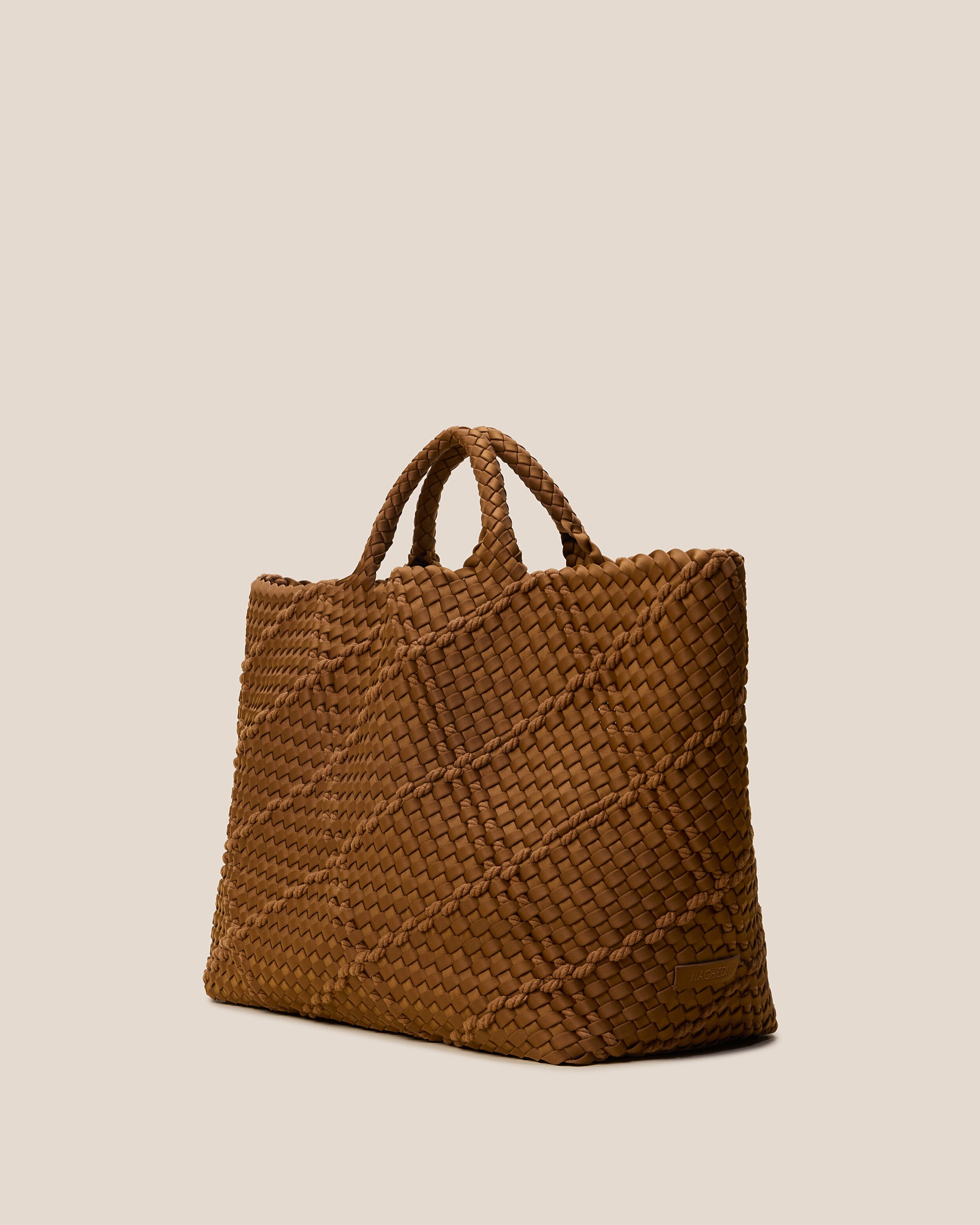 St. Barths Tote in Harbor shown from a side angle, highlighting its handwoven neoprene construction and open top.
