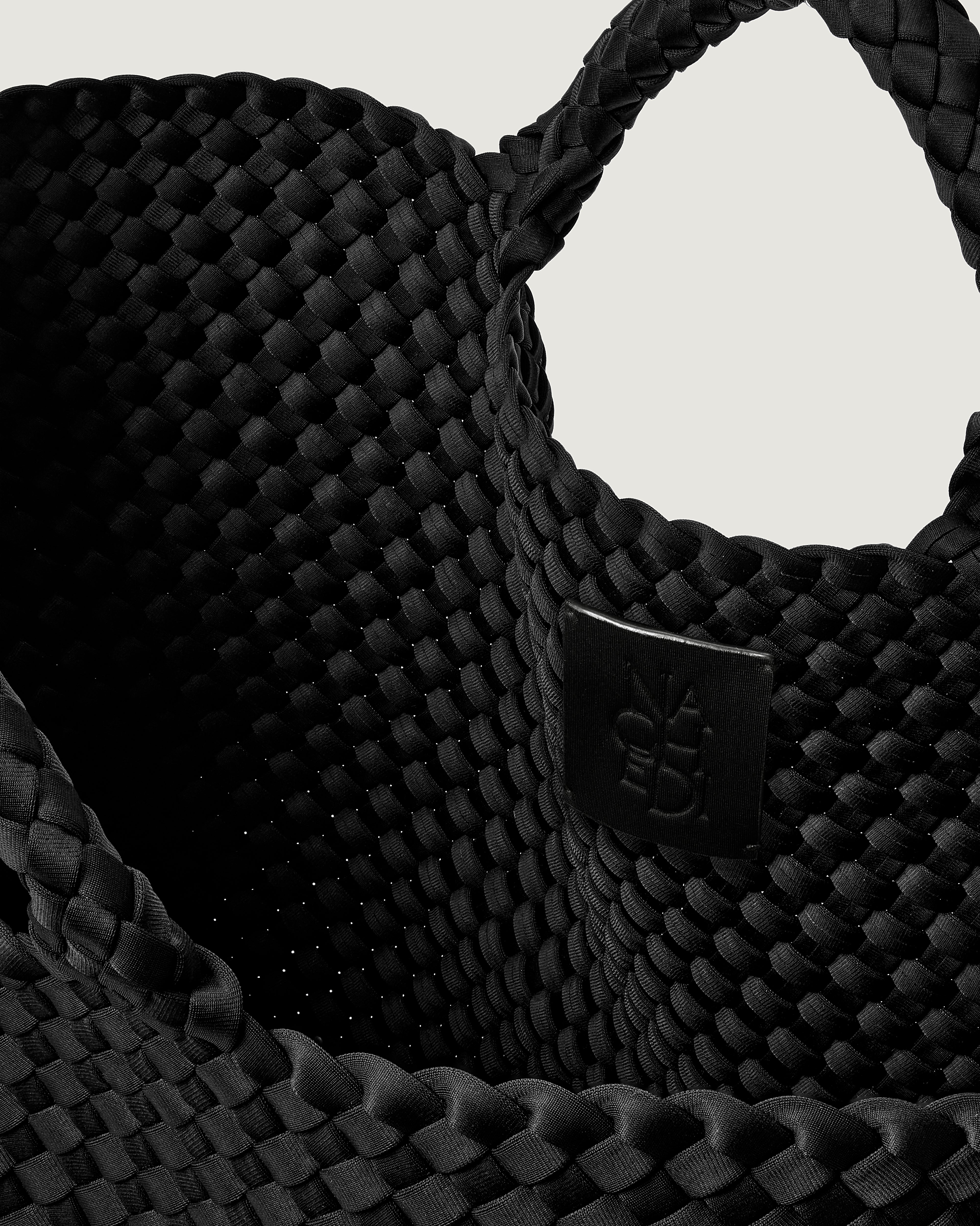 Interior close-up of St. Barths Tote in Onyx showing its open top, and unlined interior.