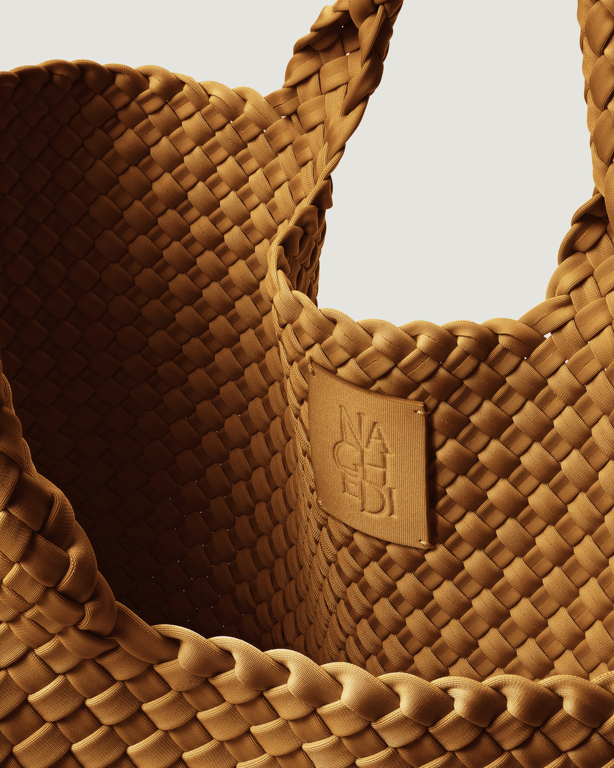Interior close-up of St. Barths Tote in Turmeric showing its open top, and unlined interior.