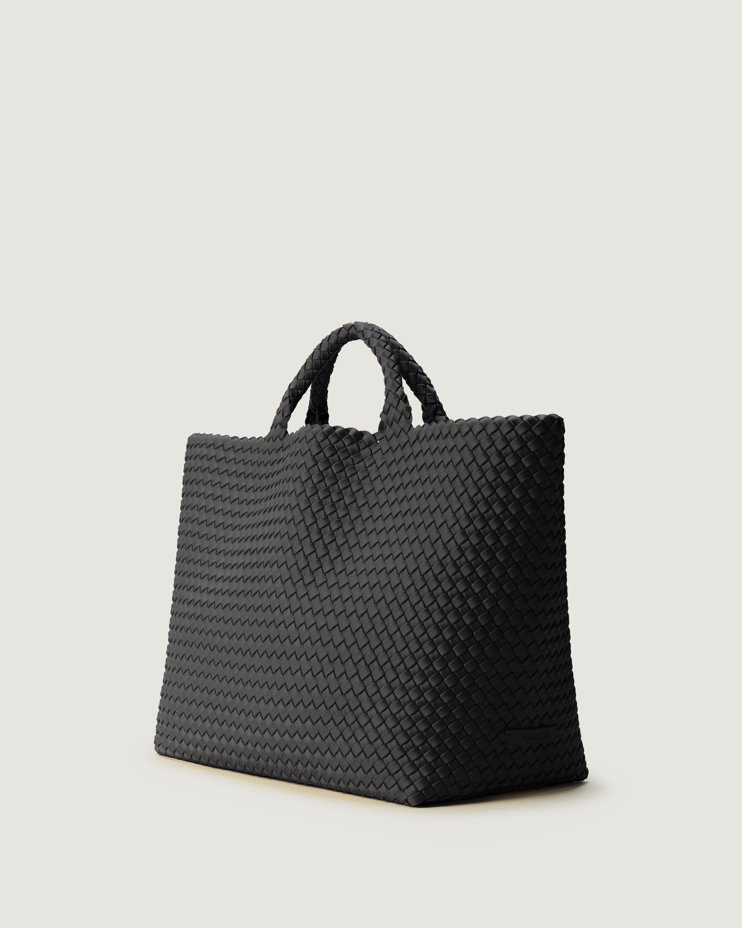St. Barths Tote in Ash shown from a side angle, highlighting its handwoven neoprene construction and open top.