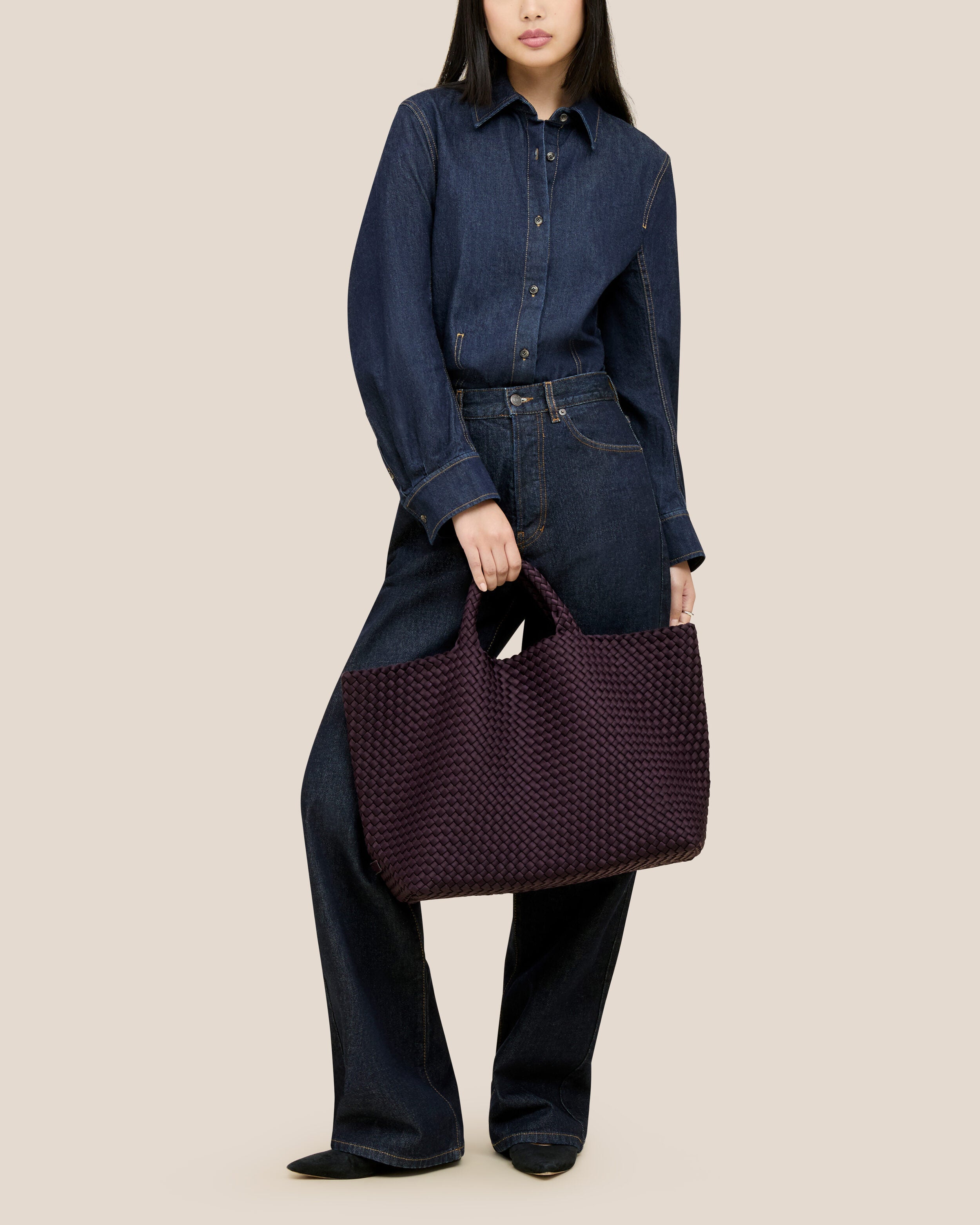 St. Barths Tote in Aubergine shown on model to illustrate scale and soft silhouette.