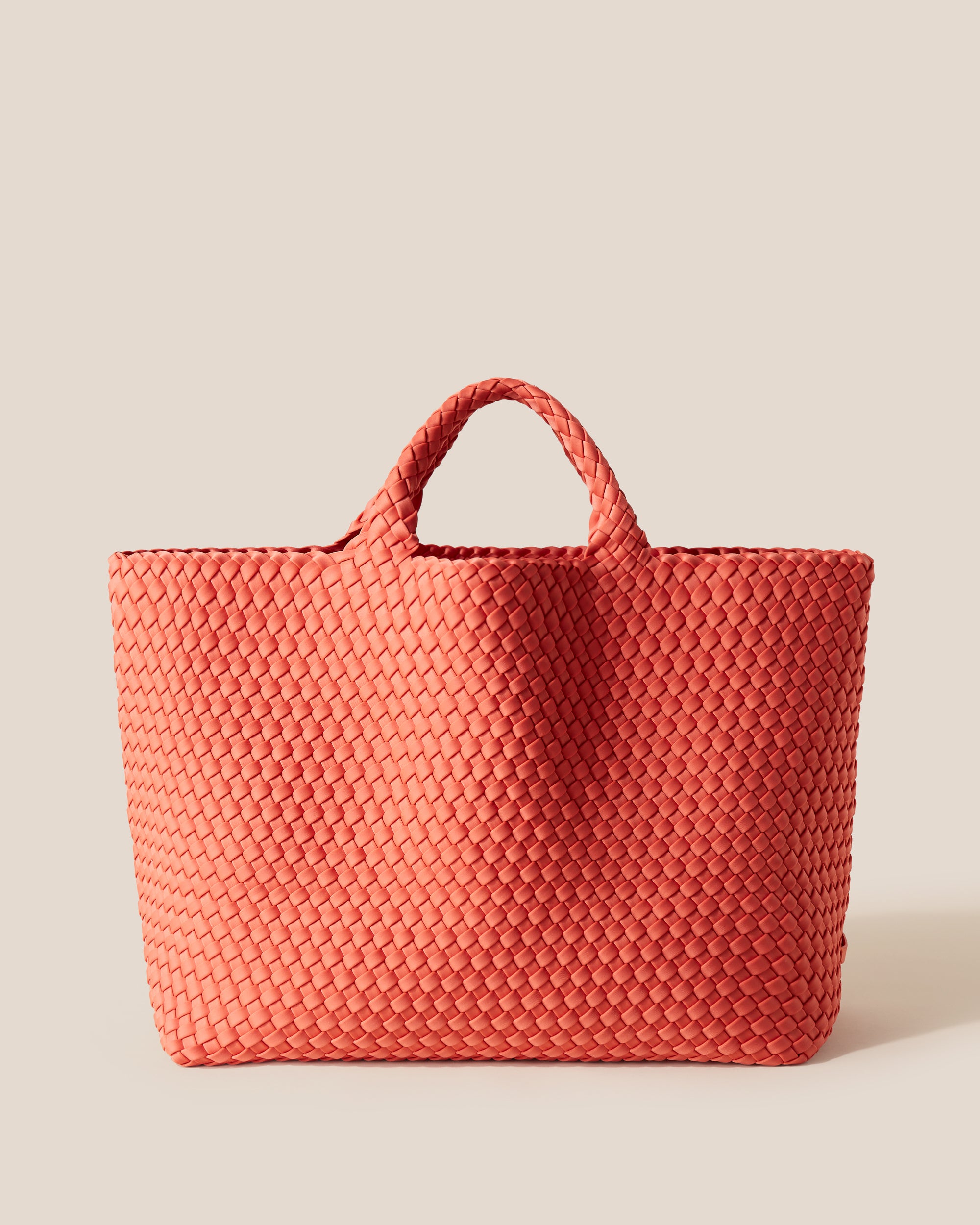 St. Barths Tote in Bonaire, a muted orange tone, in handwoven neoprene, featuring an open top, and woven top handles.
