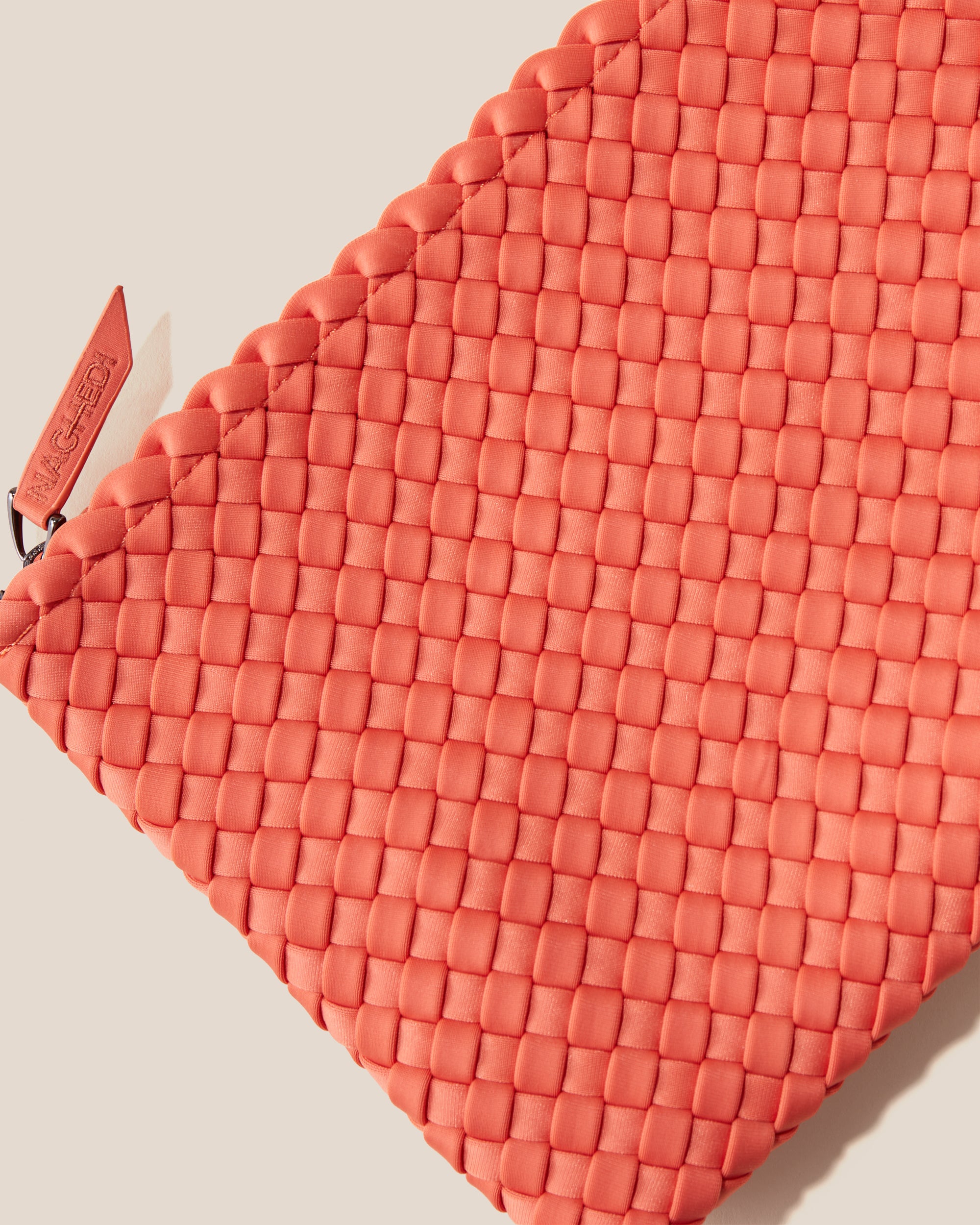 Close-up of included matching woven zippered pouch.