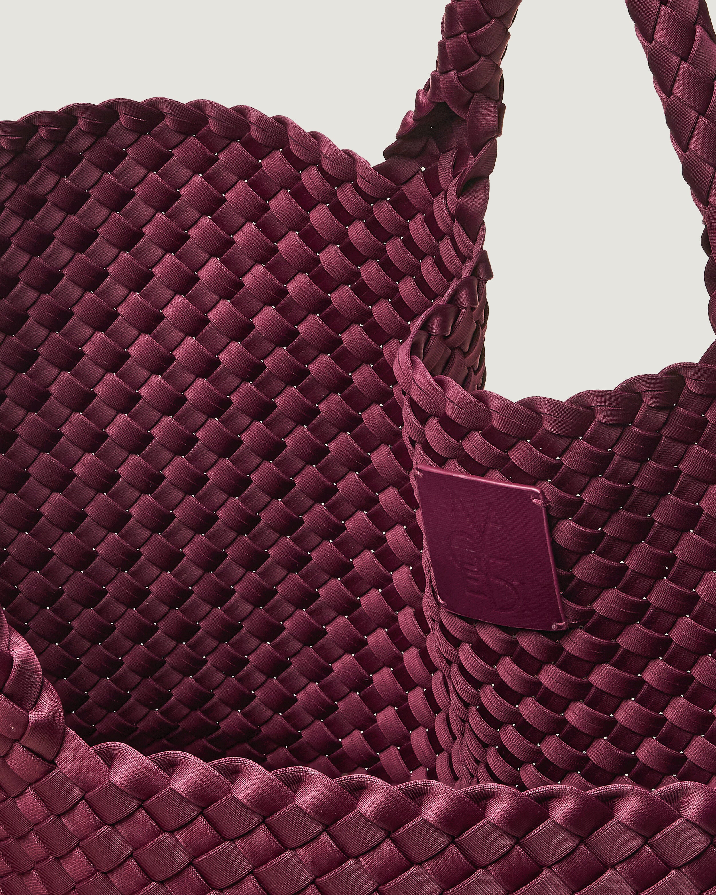 Interior close-up of St. Barths Tote in Bordeaux showing its open top, and unlined interior.